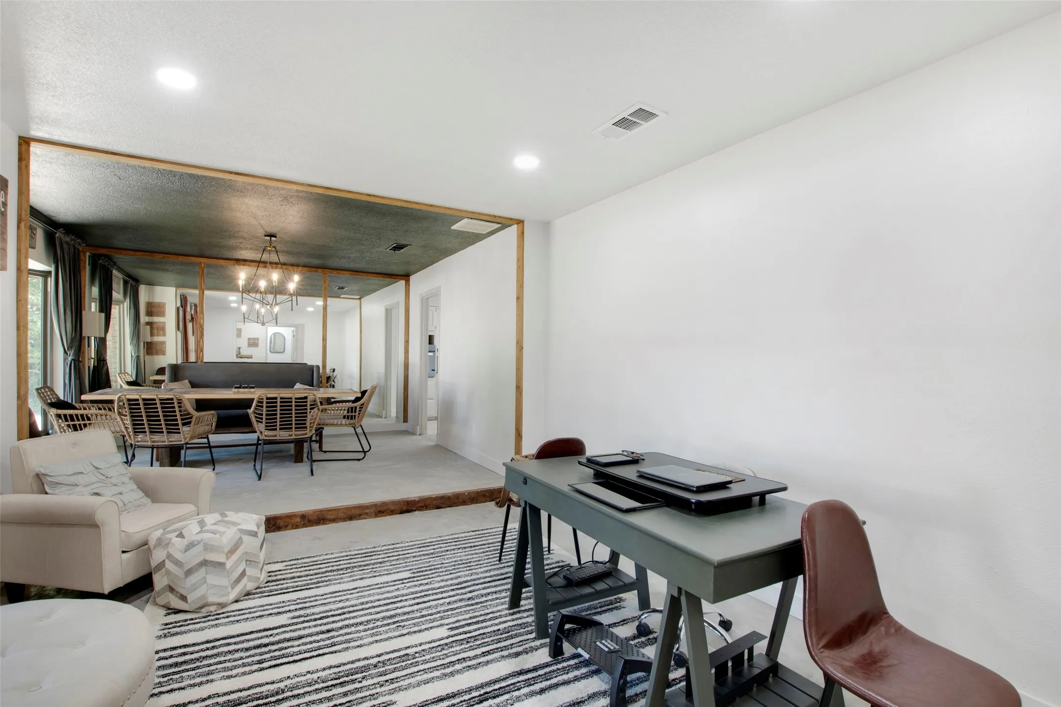 Office area featuring a textured ceiling and a notable chandelier