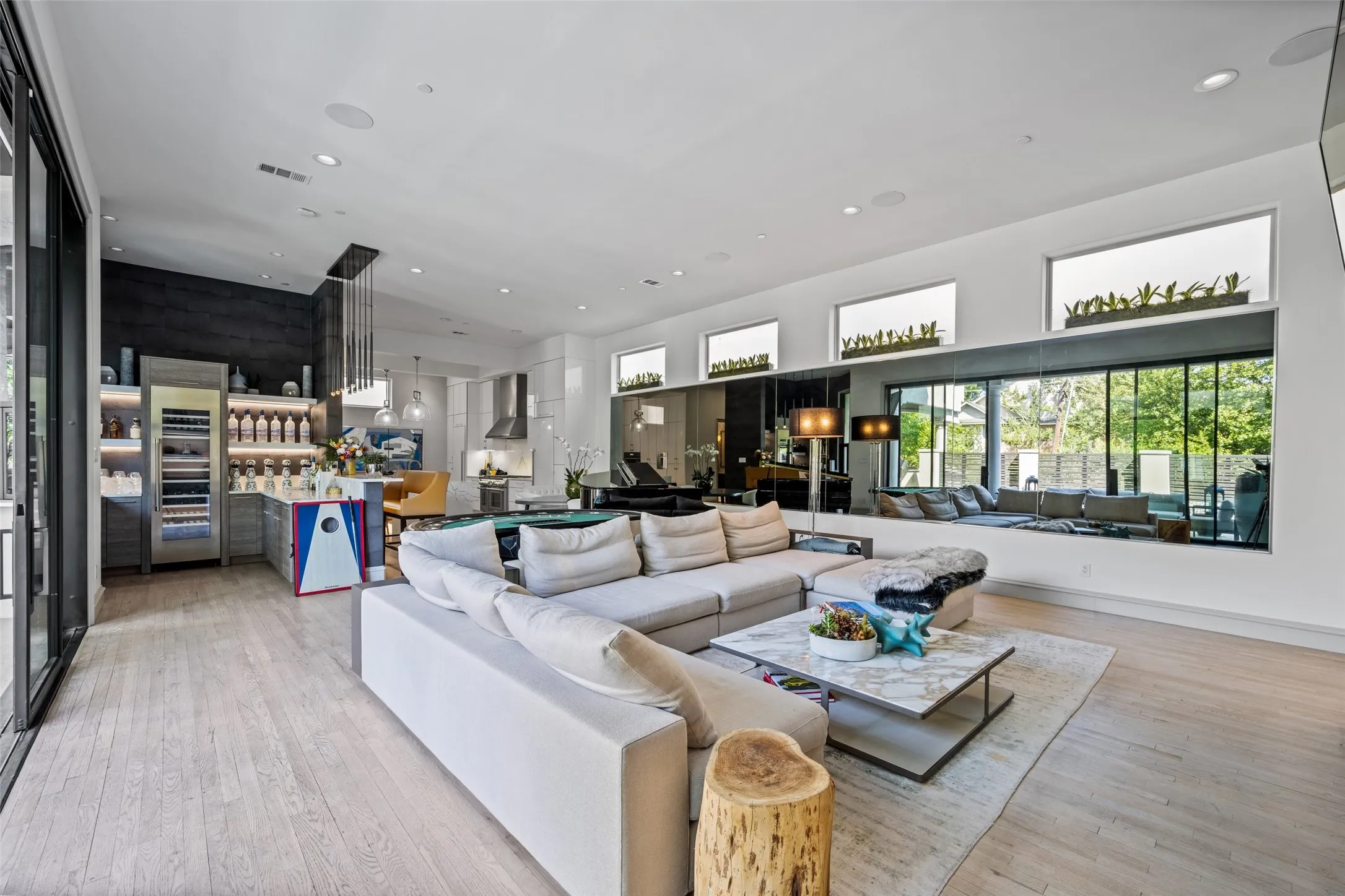 Living Area With Sliding Doors Opening to the Pool, Outdoor Kitchen and Fire Pit