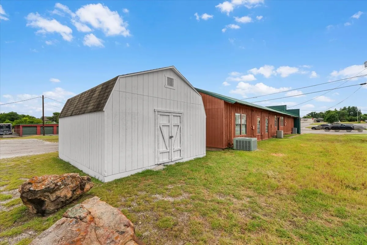 White-painted storage building with barn-style doors