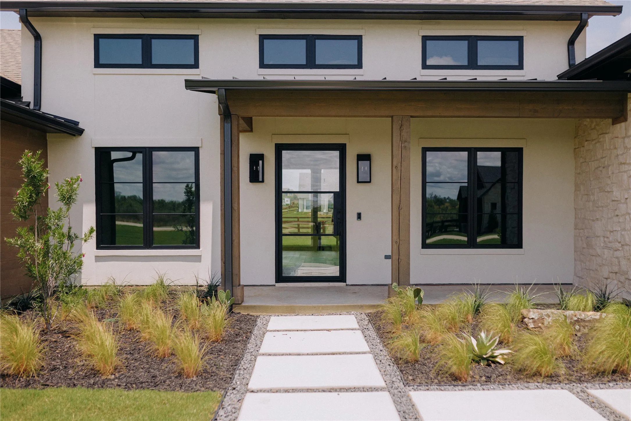 Contemporary exterior featuring stucco and stone veneer accents
