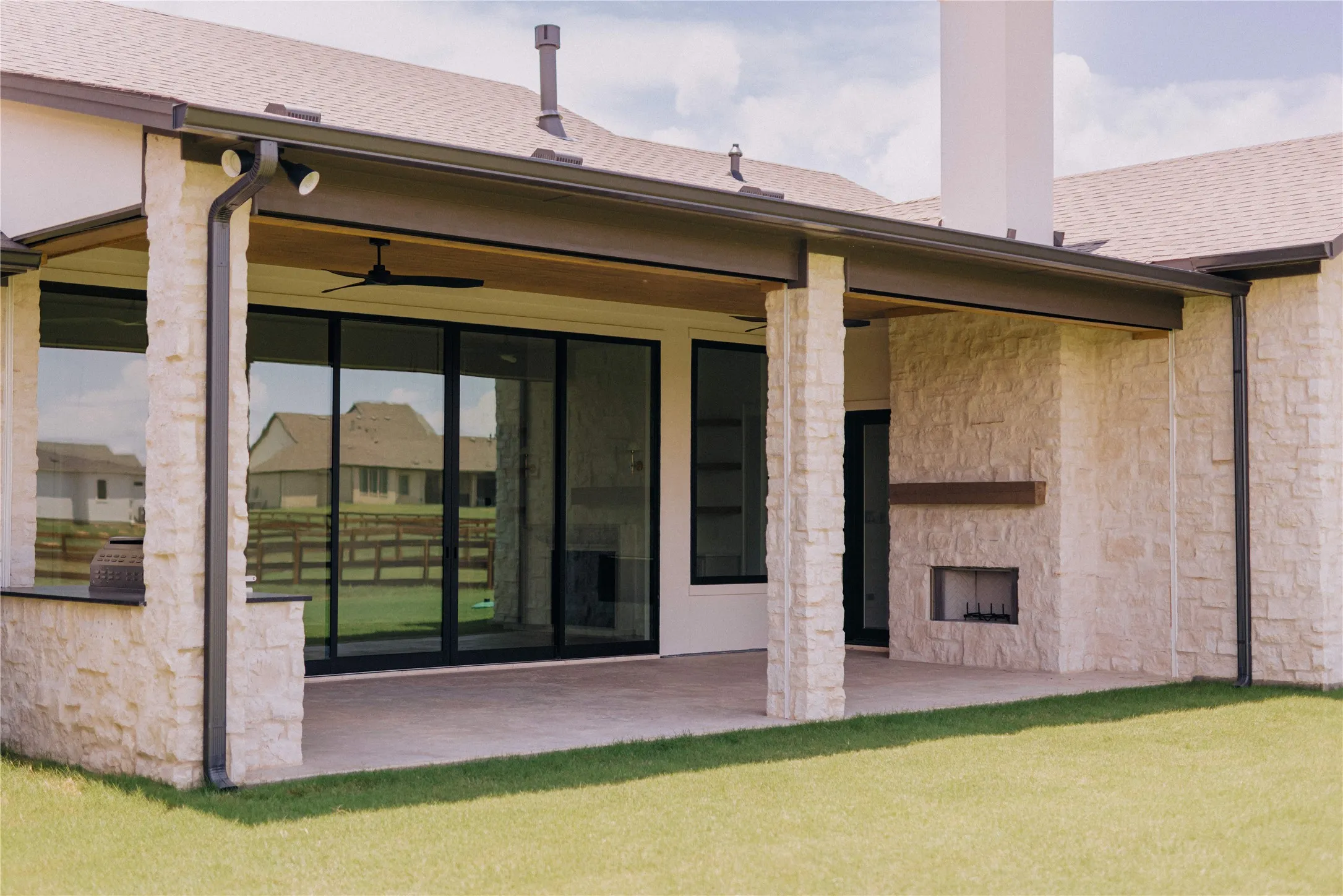 Covered patio with stone columns and matching exterior fireplace