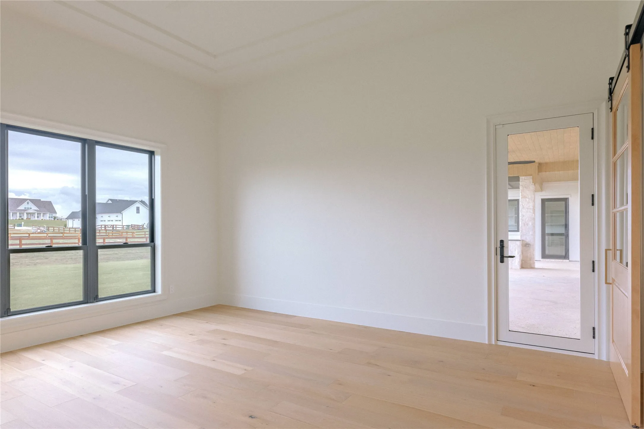 Bright and spacious room flooded with natural light through expansive sliding glass doors