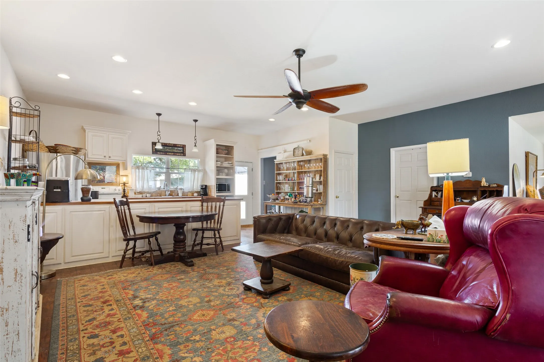 Open-concept living space featuring recessed lighting, a ceiling fan, and wood-finish flooring