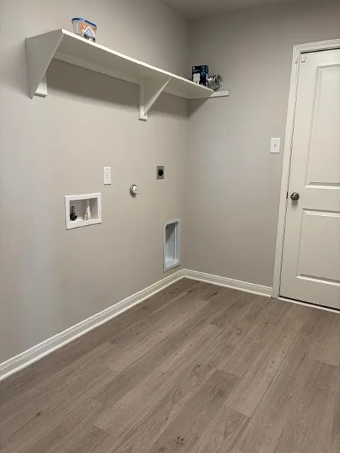 Sizable laundry room with shelf and room for a fridge