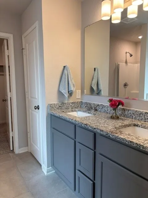 Nice storage under the vanity. Separate shower in the backgound