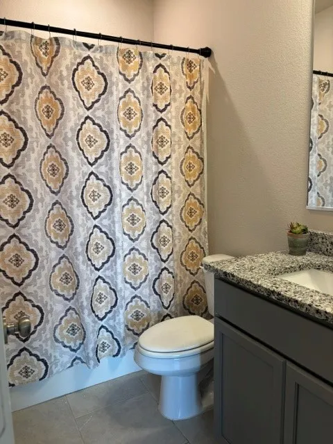 Hallway bathroom with tub shower combination and granite counter top