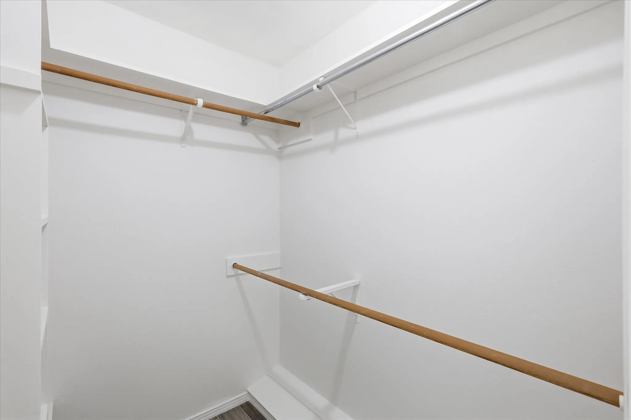 The primary suite features 2 walk-in closets with custom shelving