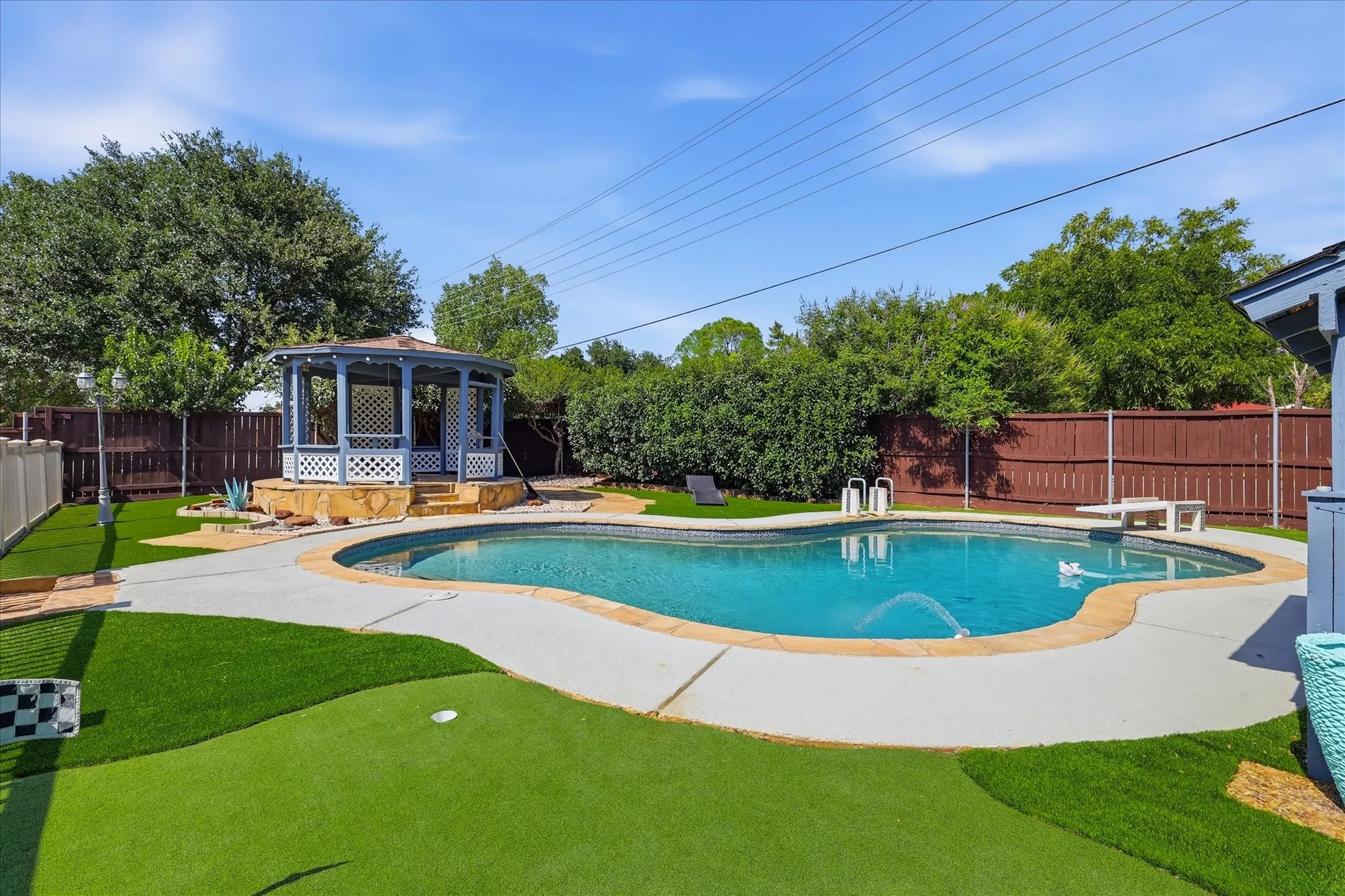 Upper tier of the putting green nest to the pool