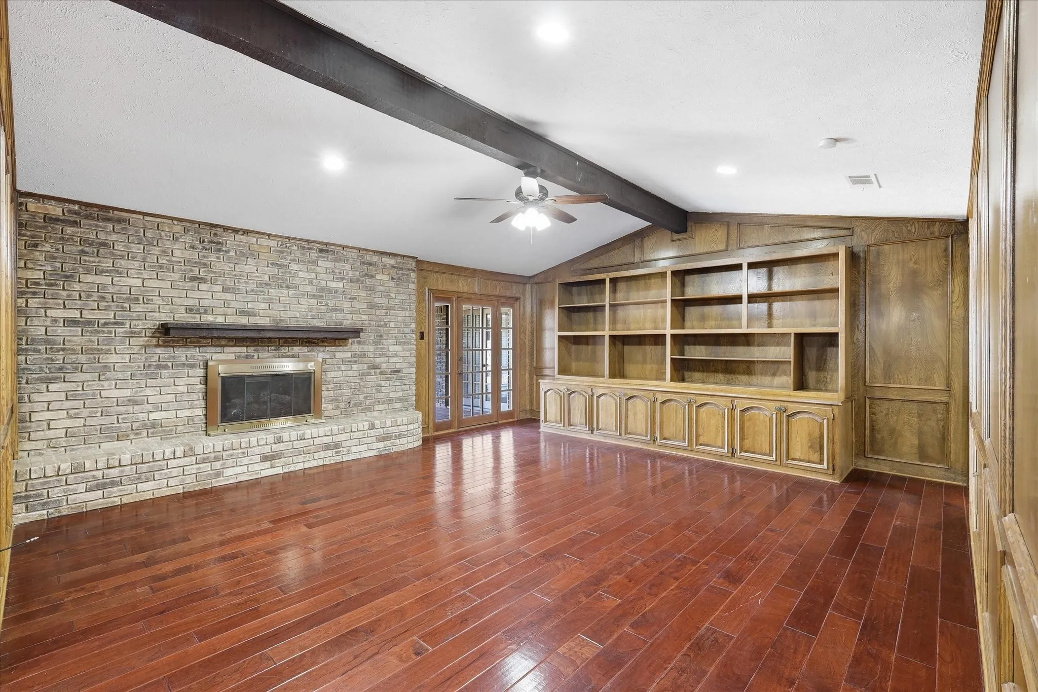 The living room features a wood-burning fireplace, cathedral ceiling, and built-in​​‌​​​​‌​​‌‌​‌‌​​​‌‌​‌​‌​‌​​​‌​​ shelving