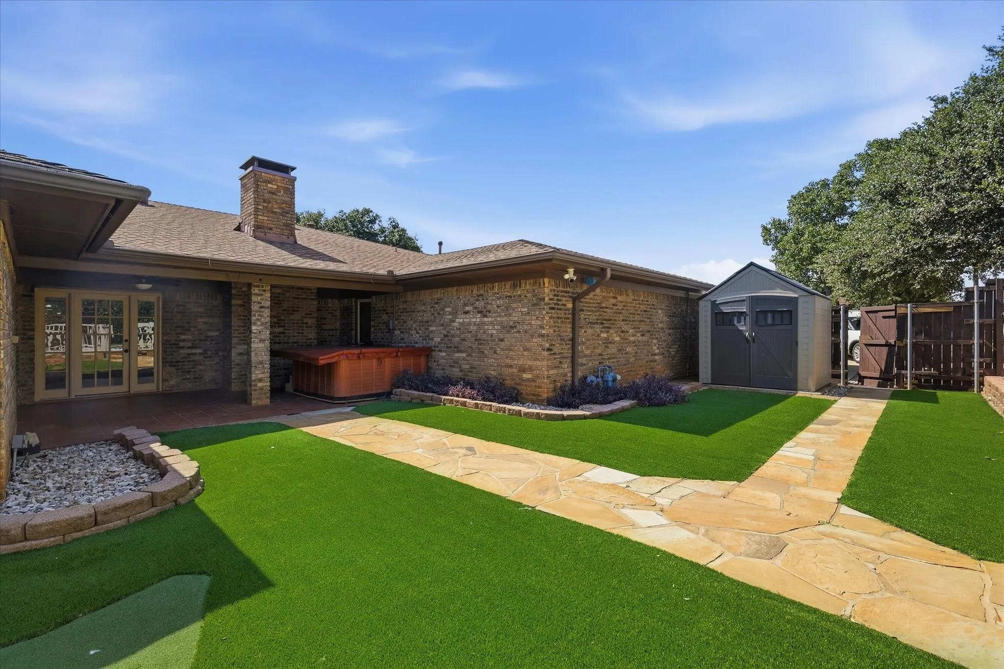 Large shed with custom shelves. The pool features a security gate, and the large gazebo overlooks the pool.
