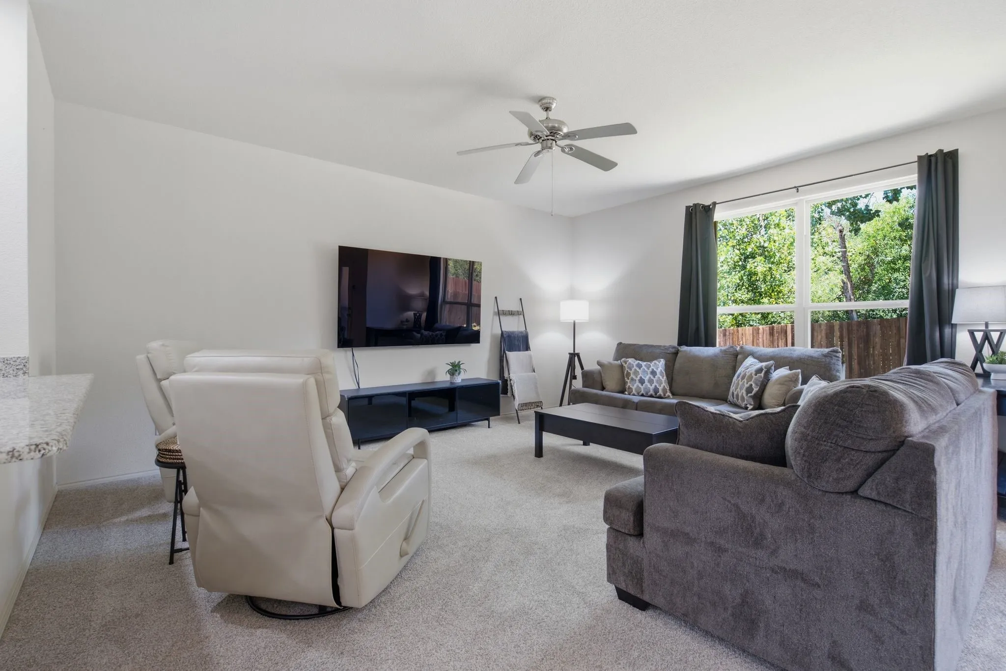 bright wall of windows in spacious living room