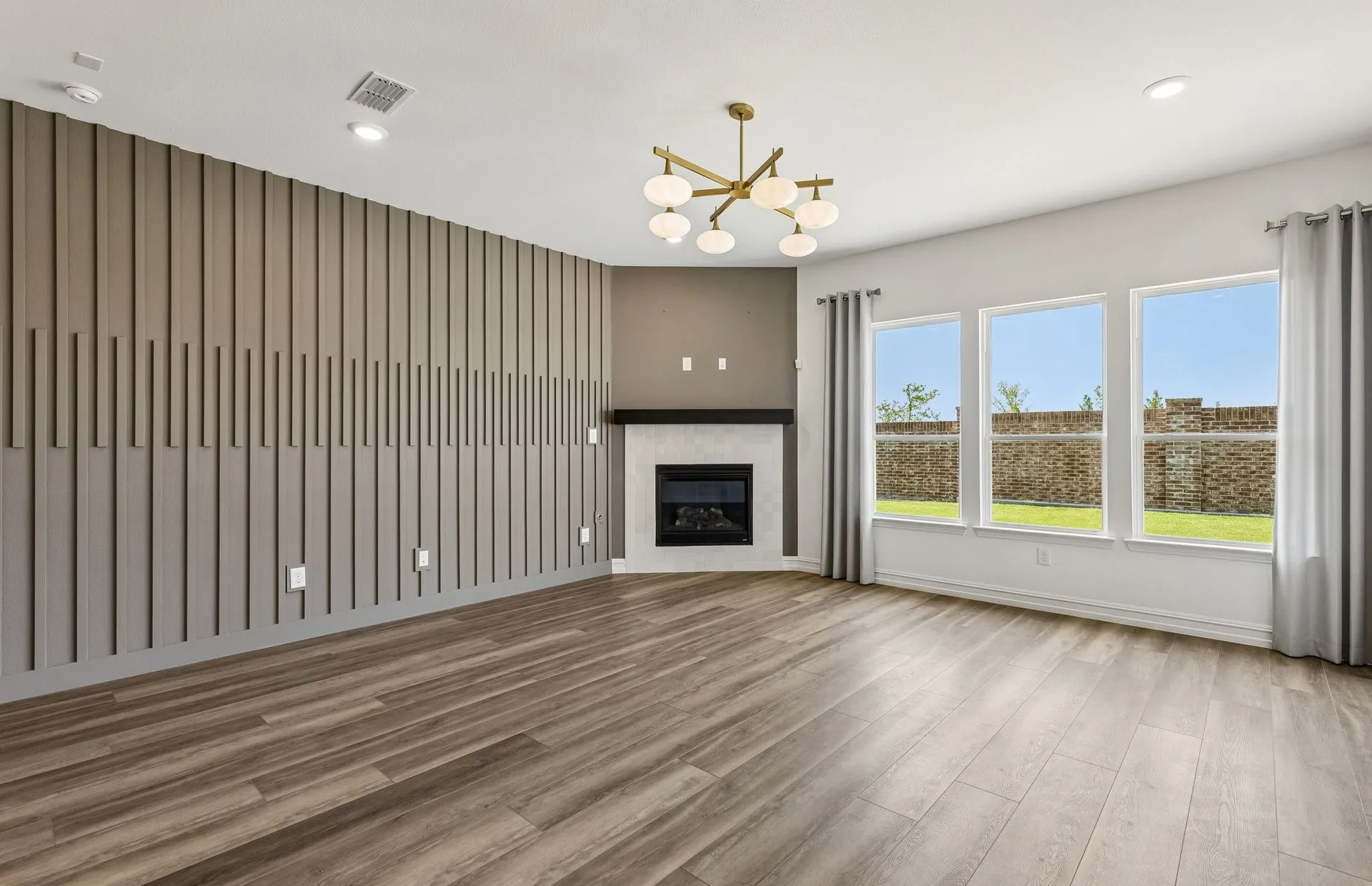 Spacious gathering room with large windows and natural light
