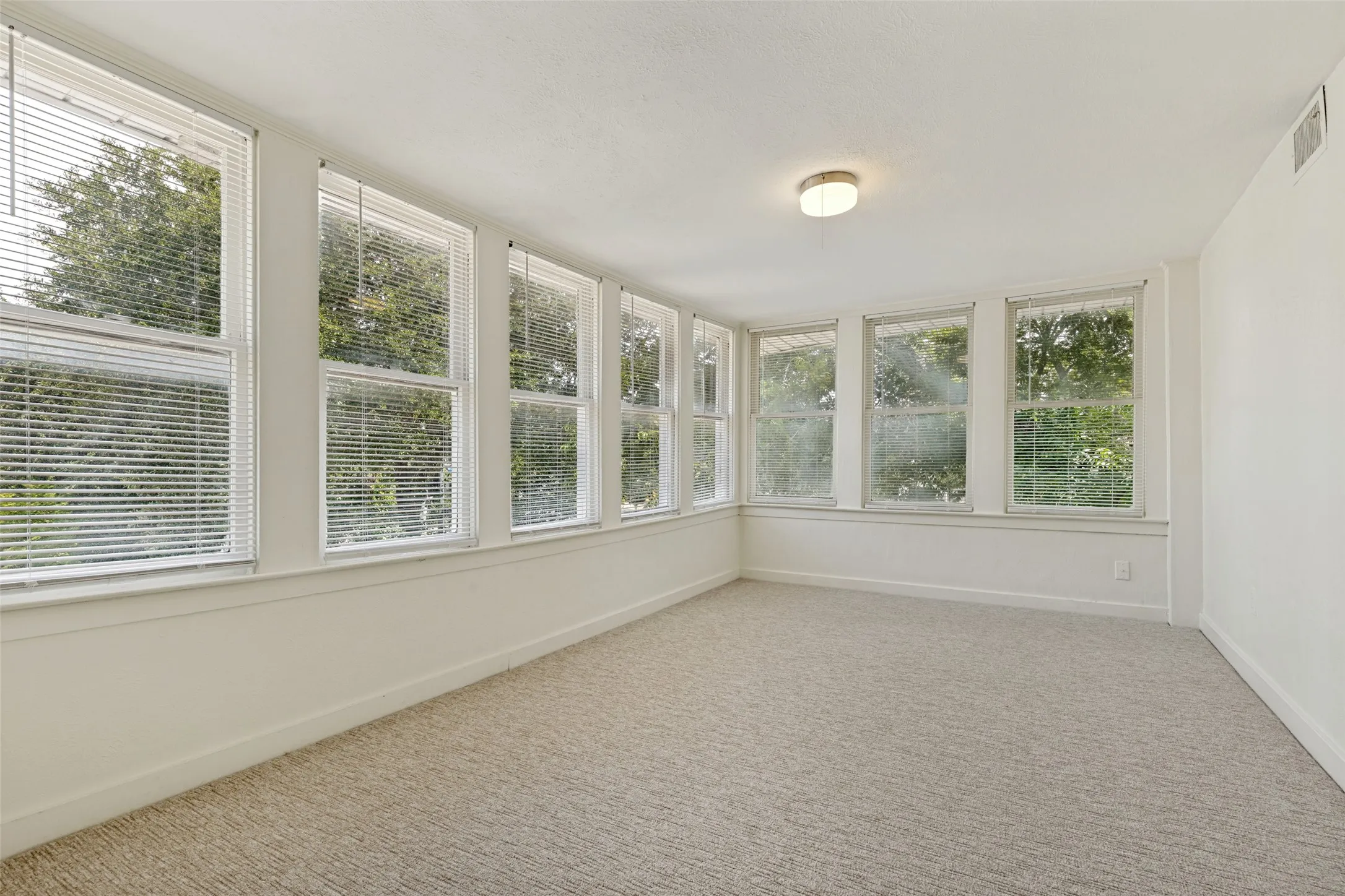 This sunroom is connected to the Primary Bedroom