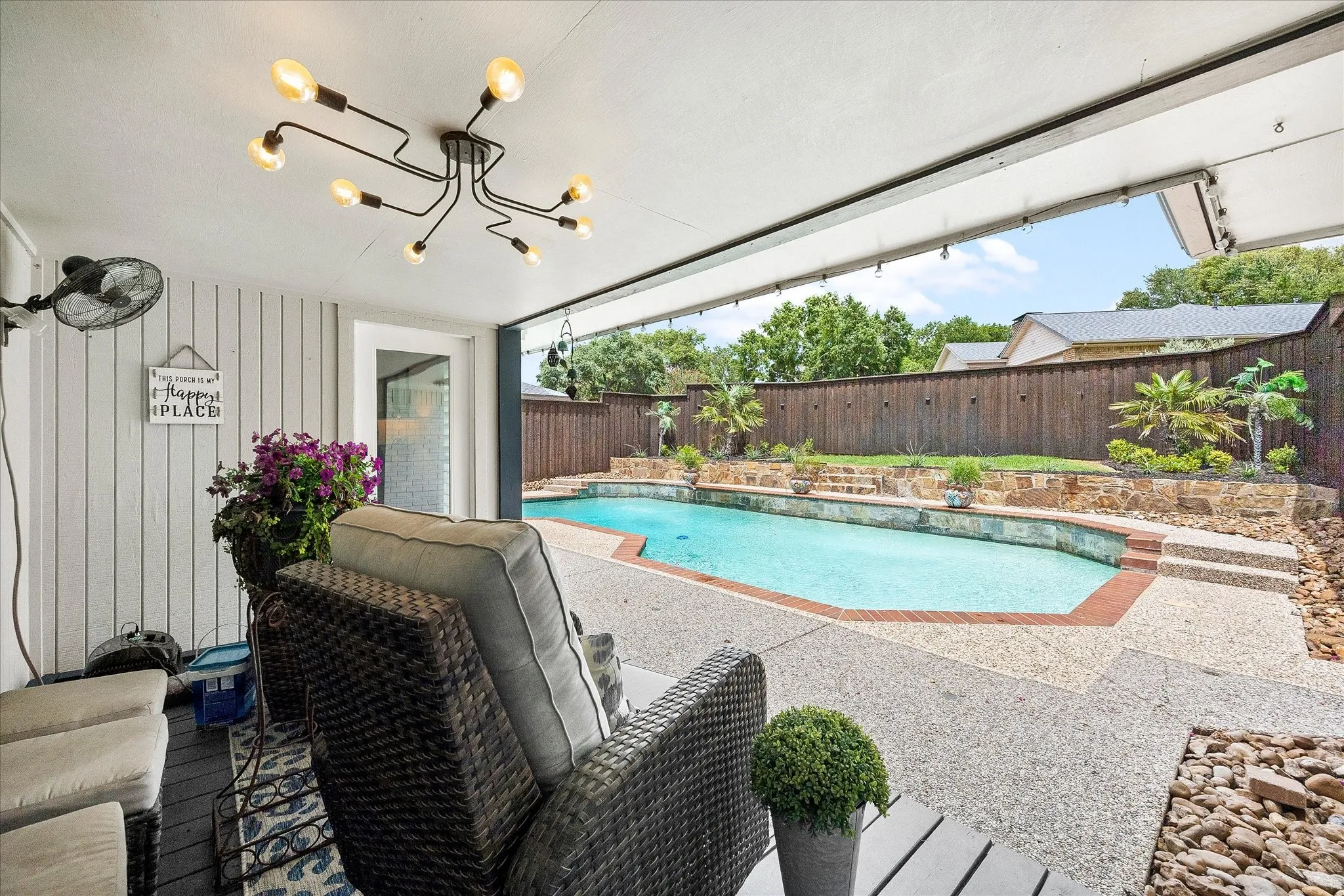 Patio overlooking pool and private backyard.