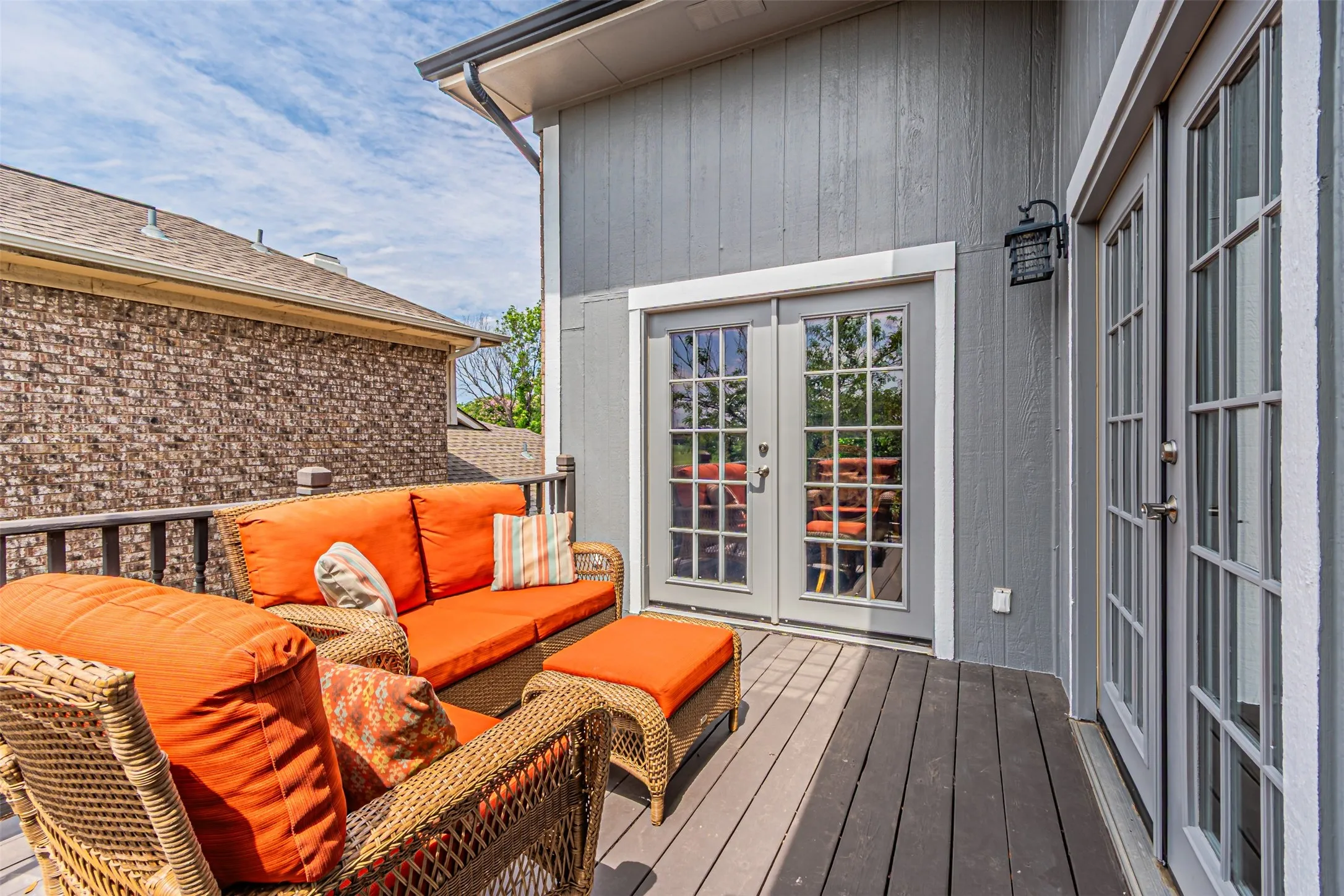 Expansive outdoor deck featuring wood-finish flooring and a dark wood railing