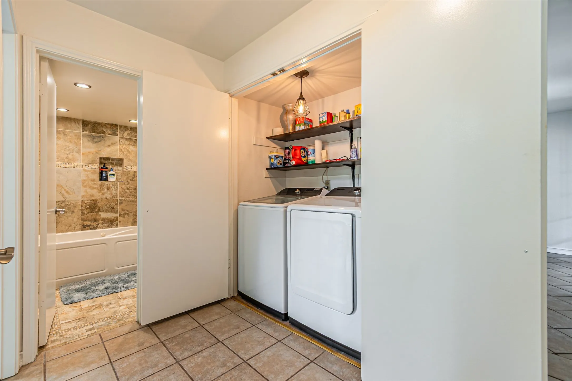 Laundry area featuring tile flooring, built-in shelving, and recessed lighting