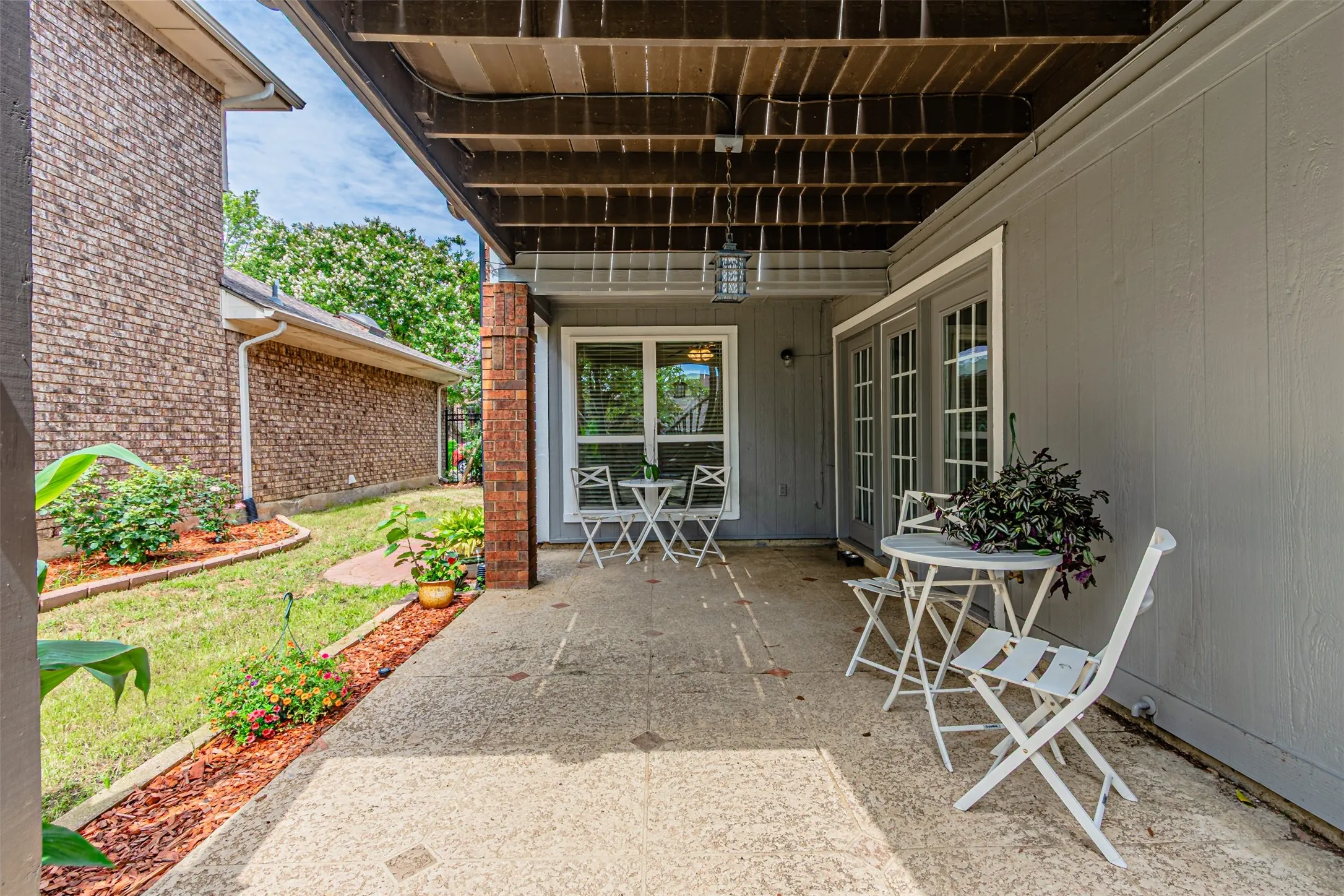 Covered patio featuring concrete flooring and a wood-slat ceiling