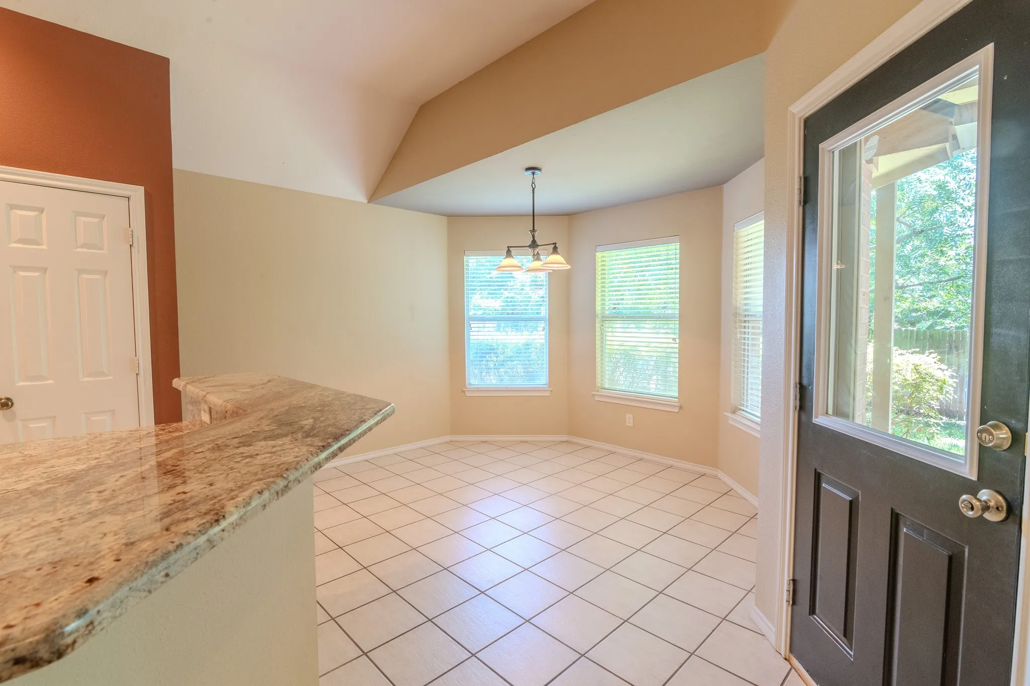 room with tiled floors and bay windows
