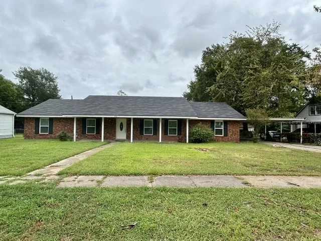 Brick exterior with a covered front porch featuring white columns