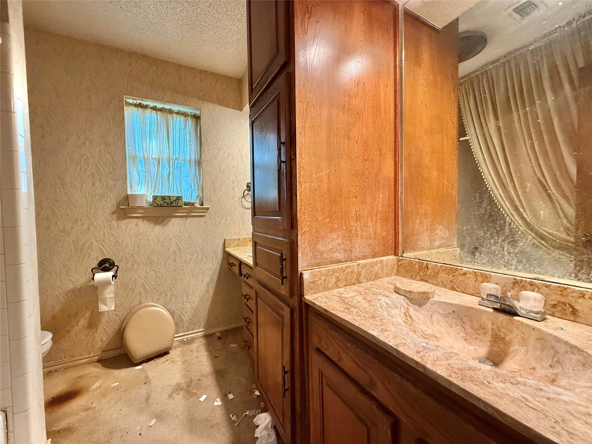 Bathroom vanity featuring an integrated sink, built-in cabinetry, and a mirrored wall