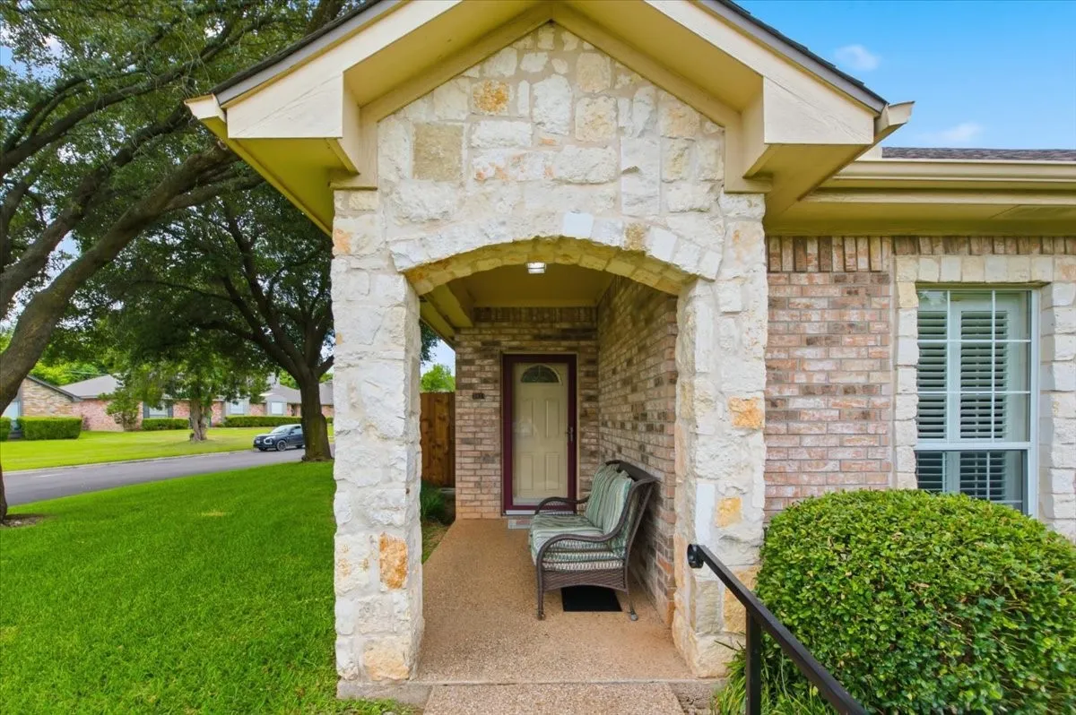Stone and brick exterior with an arched entryway