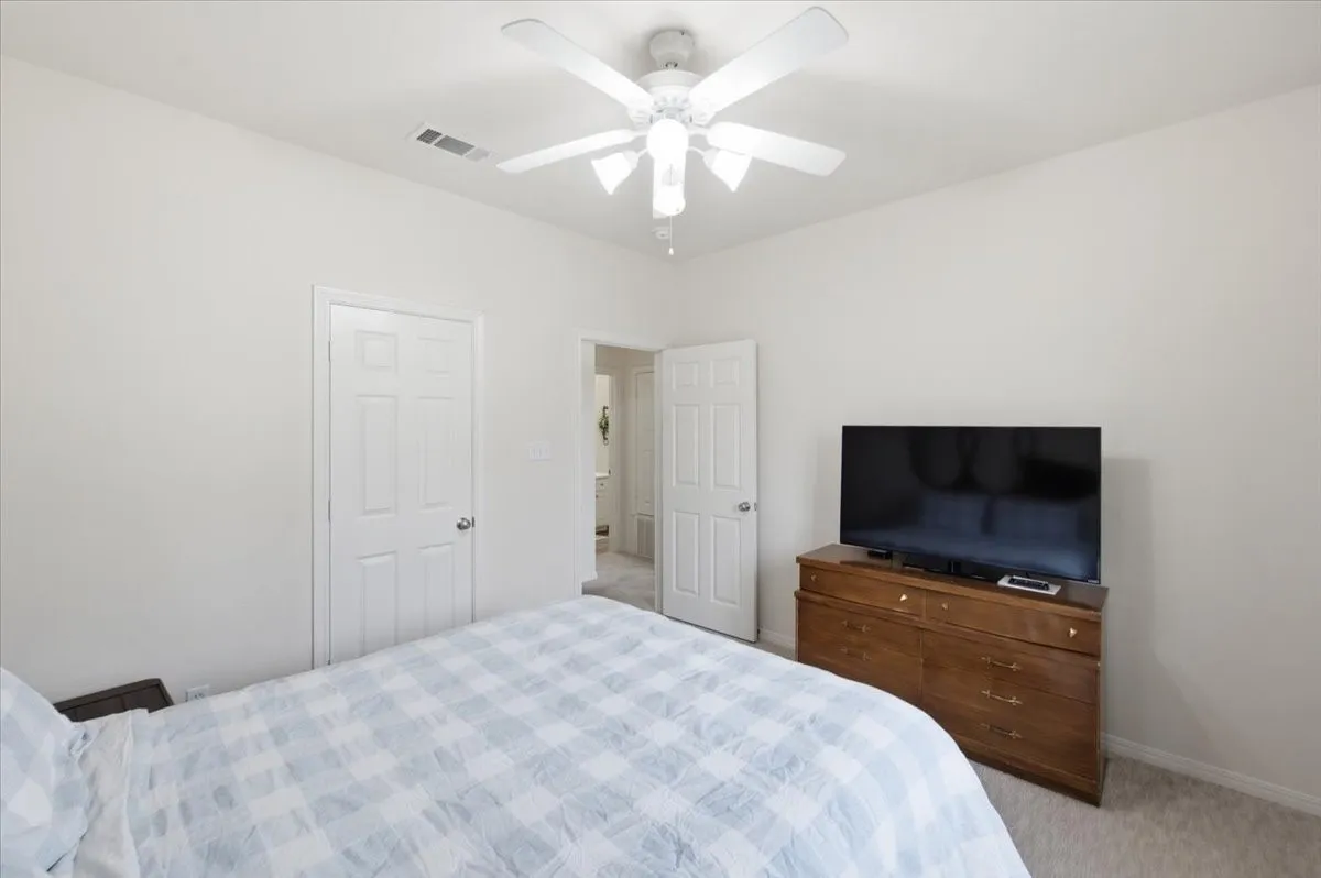 Bedroom featuring light-colored walls and carpeted flooring
