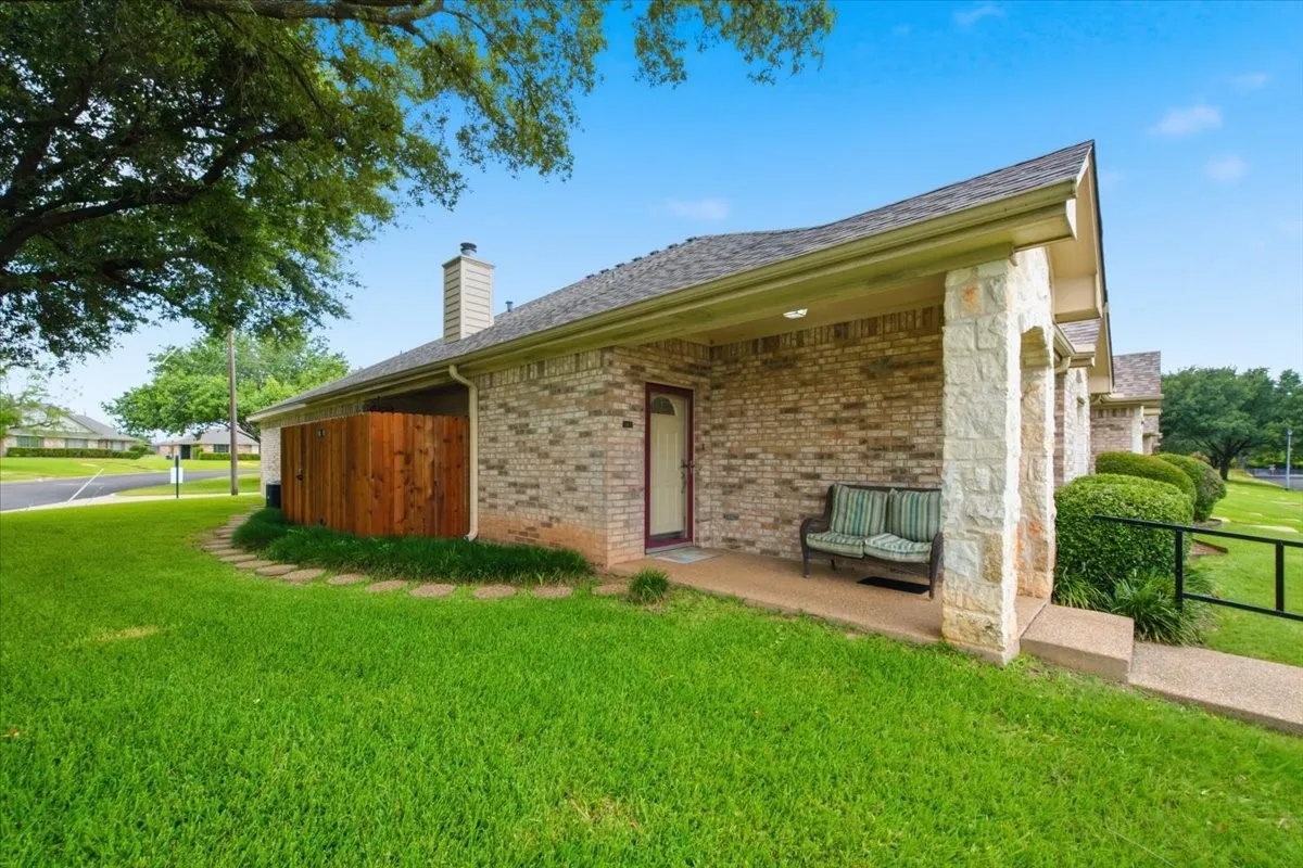 Covered front door entrance and privacy fenced patio.