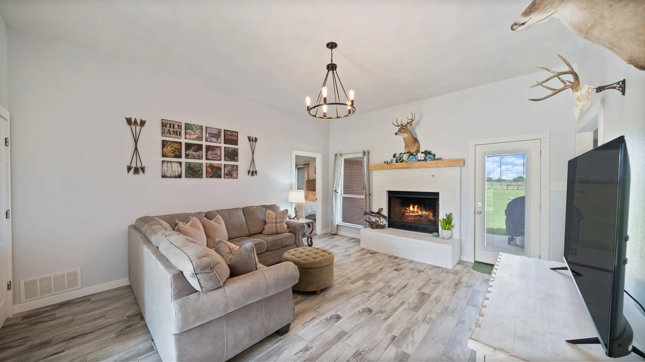 Living room featuring lighting and gas fireplace