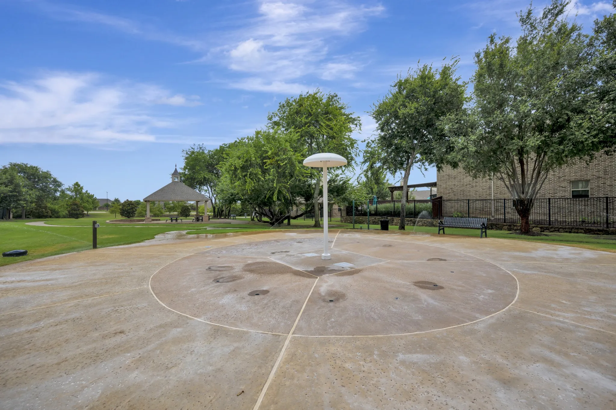 Community splash pad with integrated water features and surrounding green space