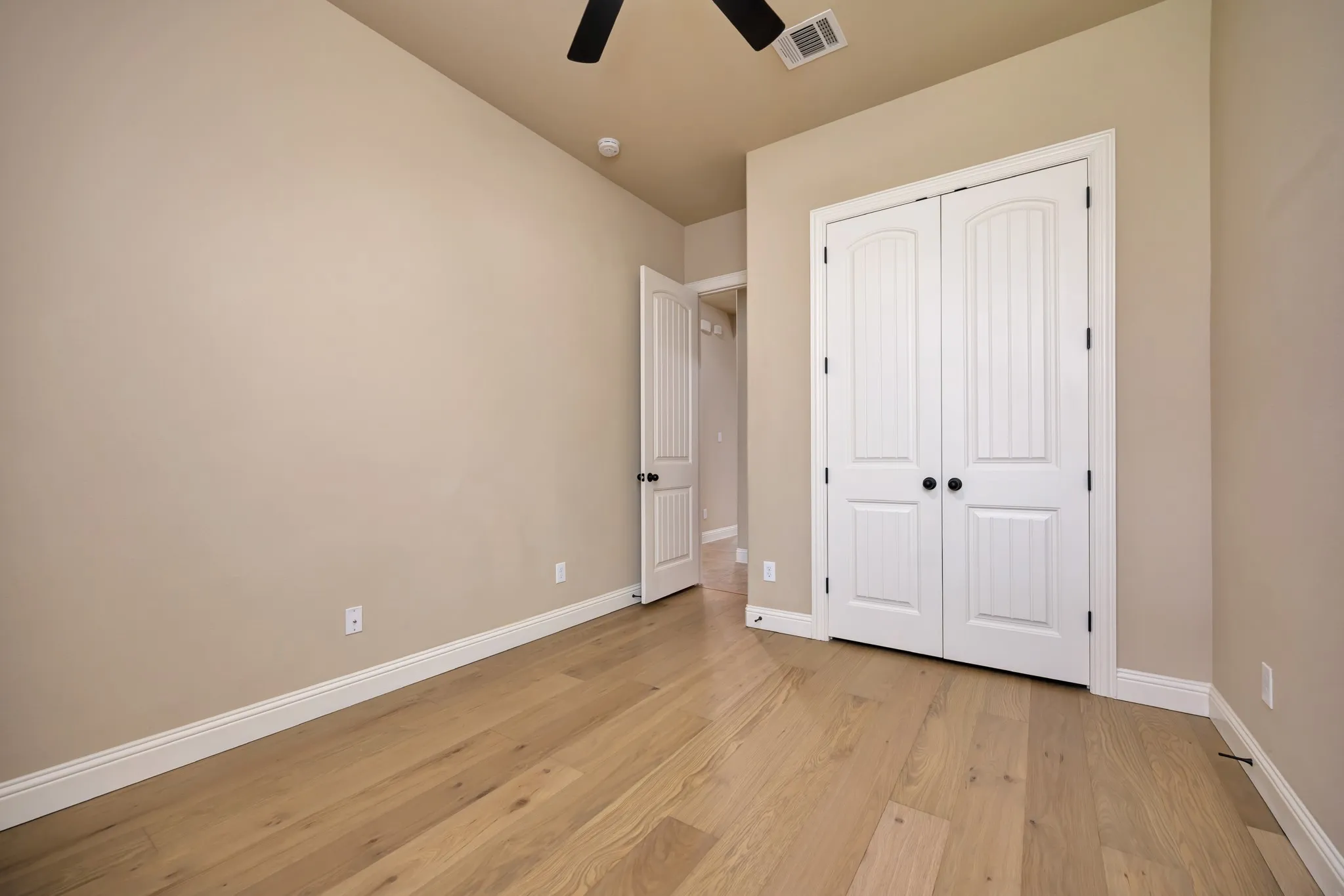 Room featuring light wood-finish flooring, neutral wall tones, and white baseboards