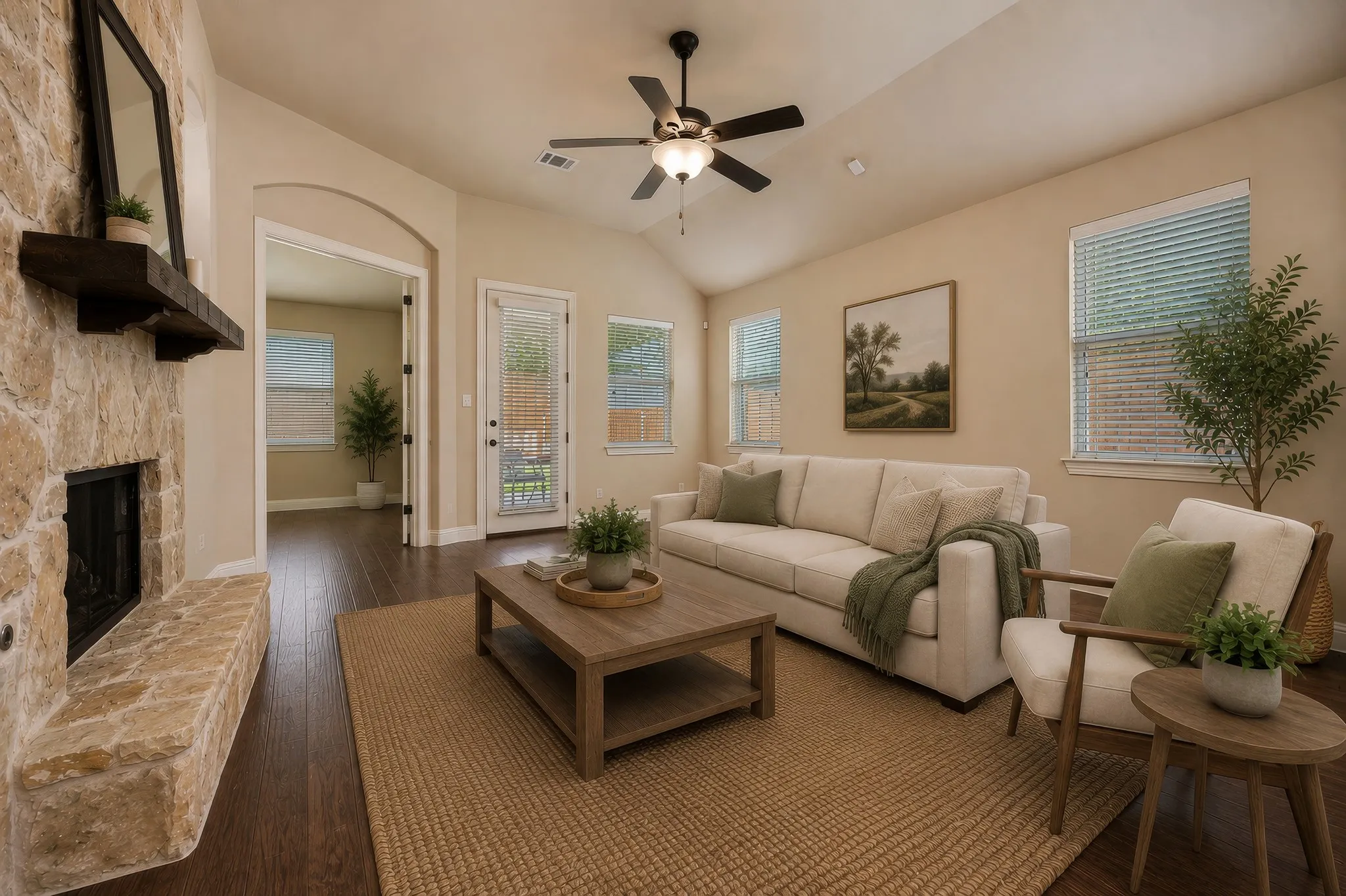 Spacious living area featuring a stone fireplace with a wood mantle, vaulted ceilings, and wood-finish flooring
Virtual Staging