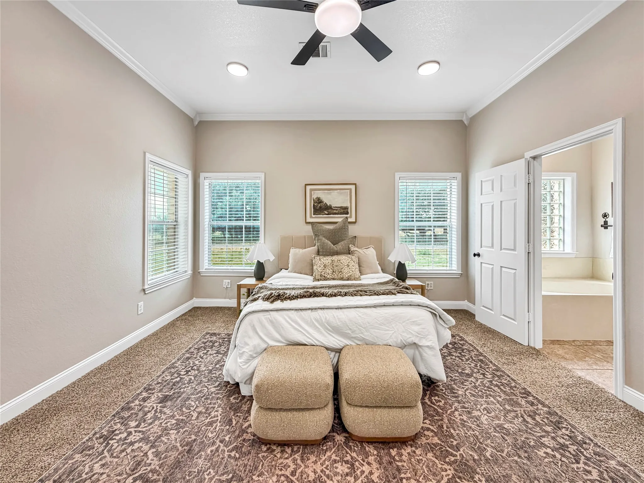 Spacious room featuring neutral paint, crown molding, and two windows with blinds