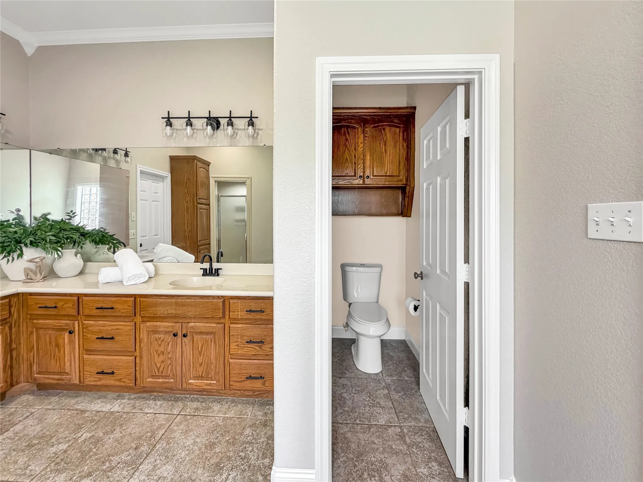 Double vanity with an integrated sink, light-toned countertop, and dark-finished faucet