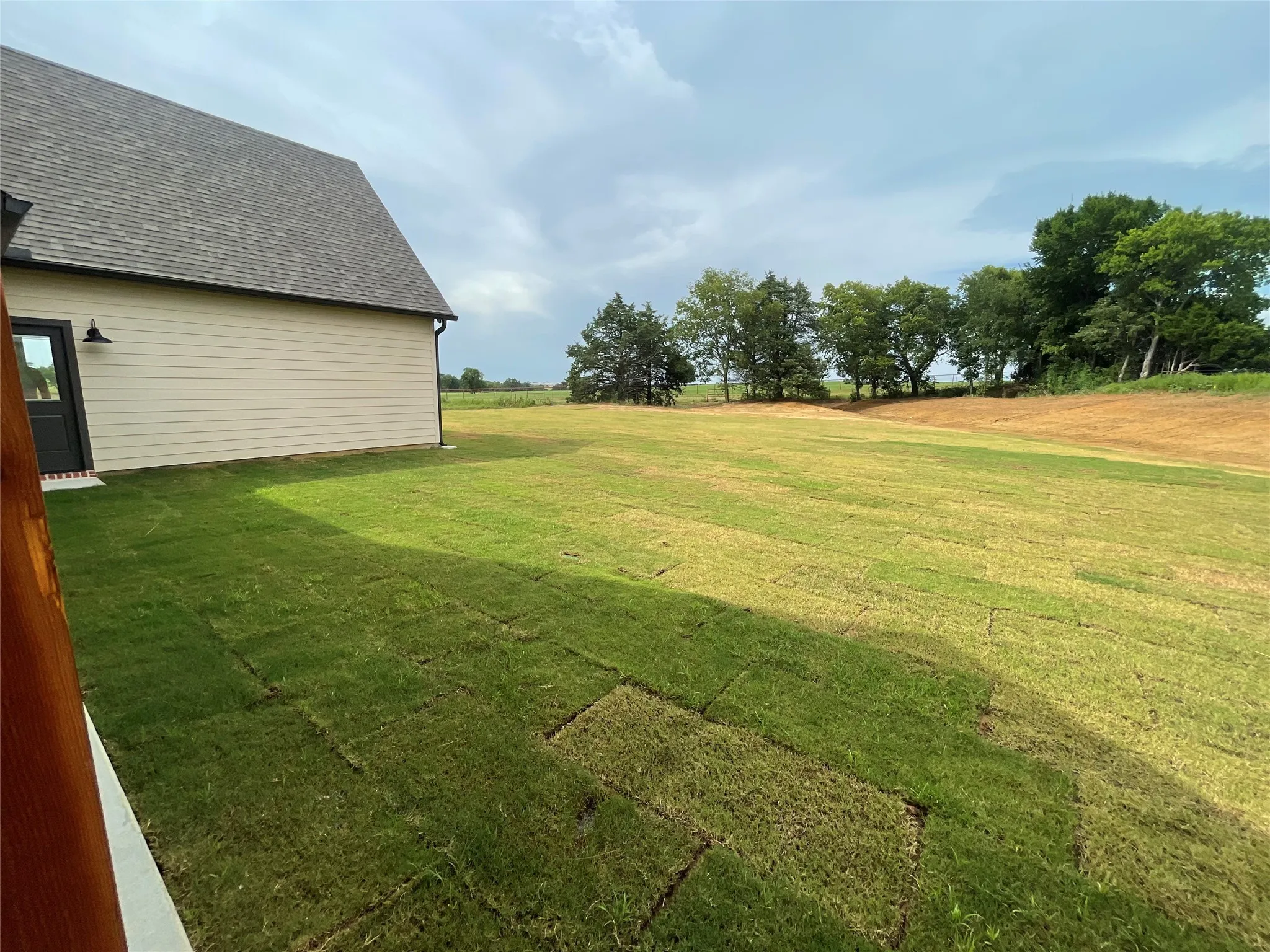 Expansive green lawn with newly laid sod