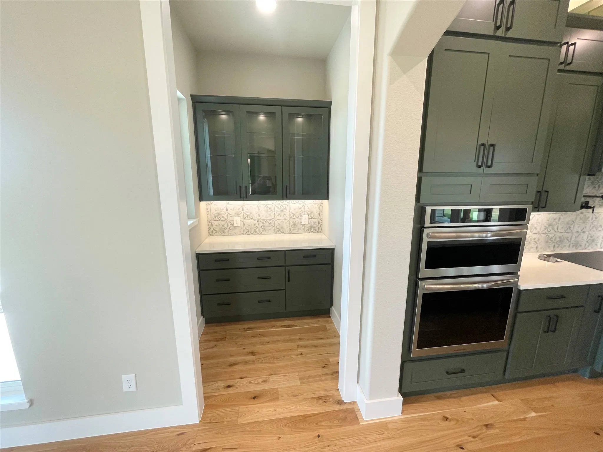 Butlers pantry with glass display hutch