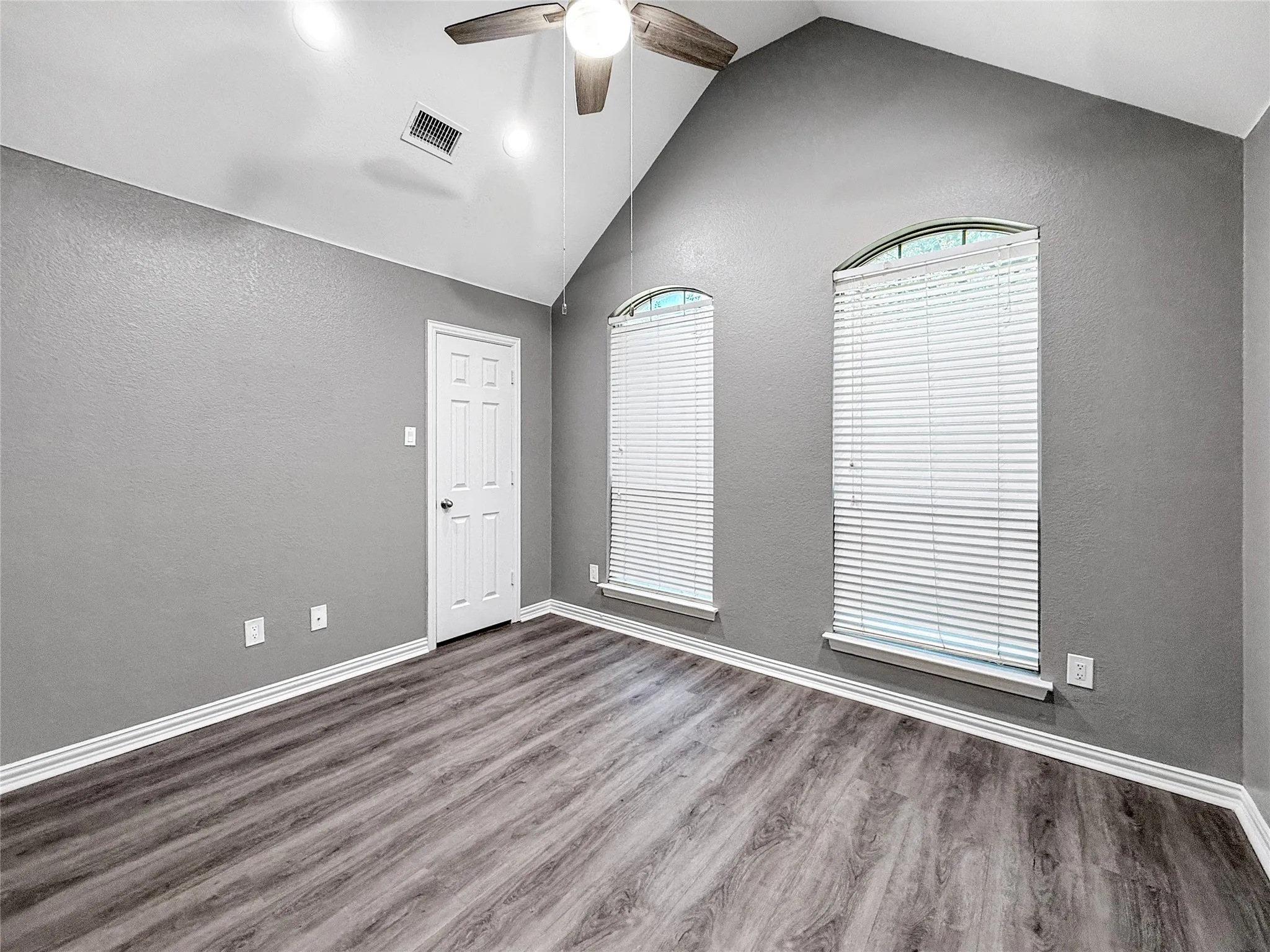 Room featuring a vaulted ceiling with recessed lighting and a ceiling fan