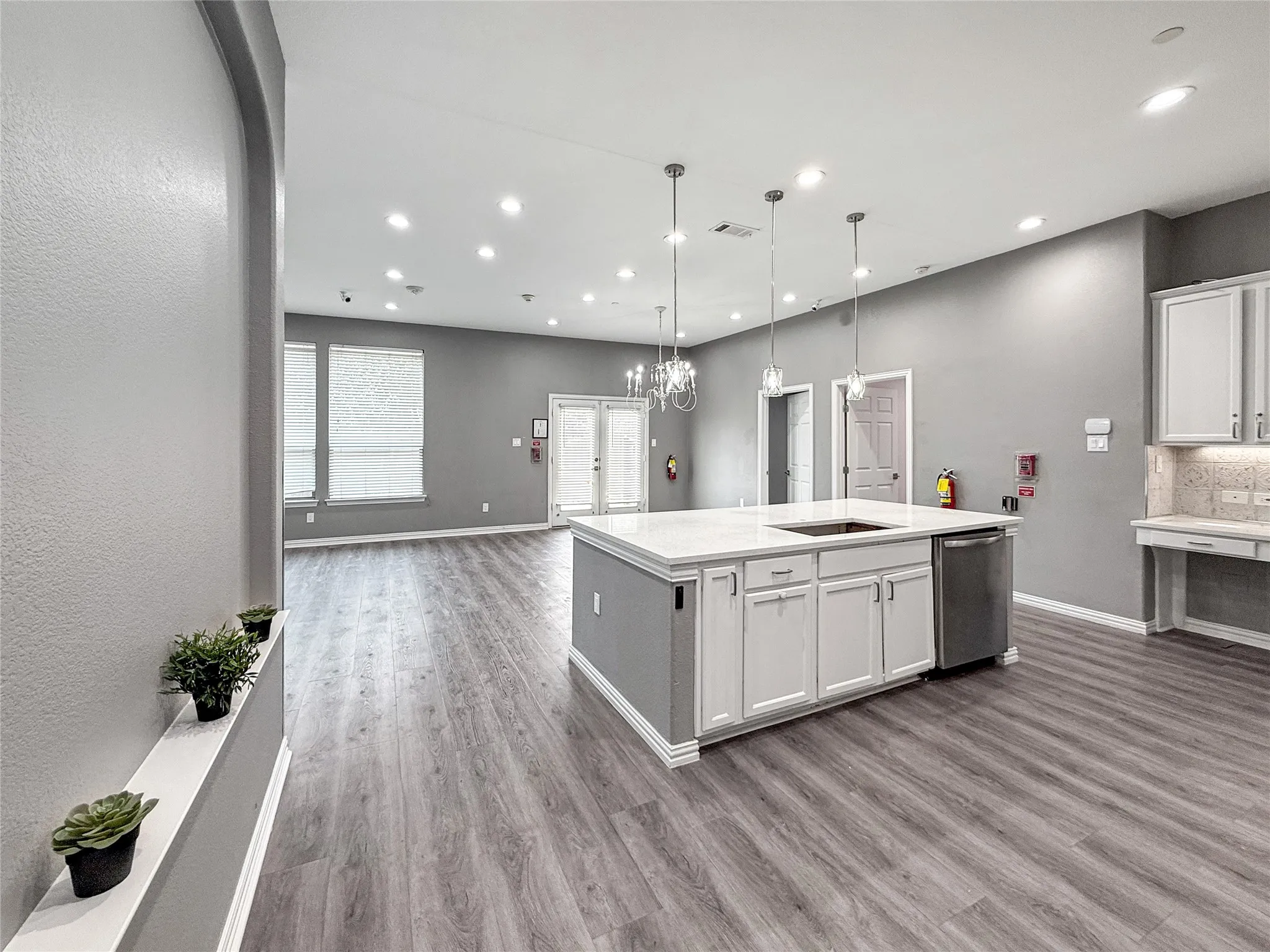 Spacious open-concept interior featuring wood-finish flooring throughout