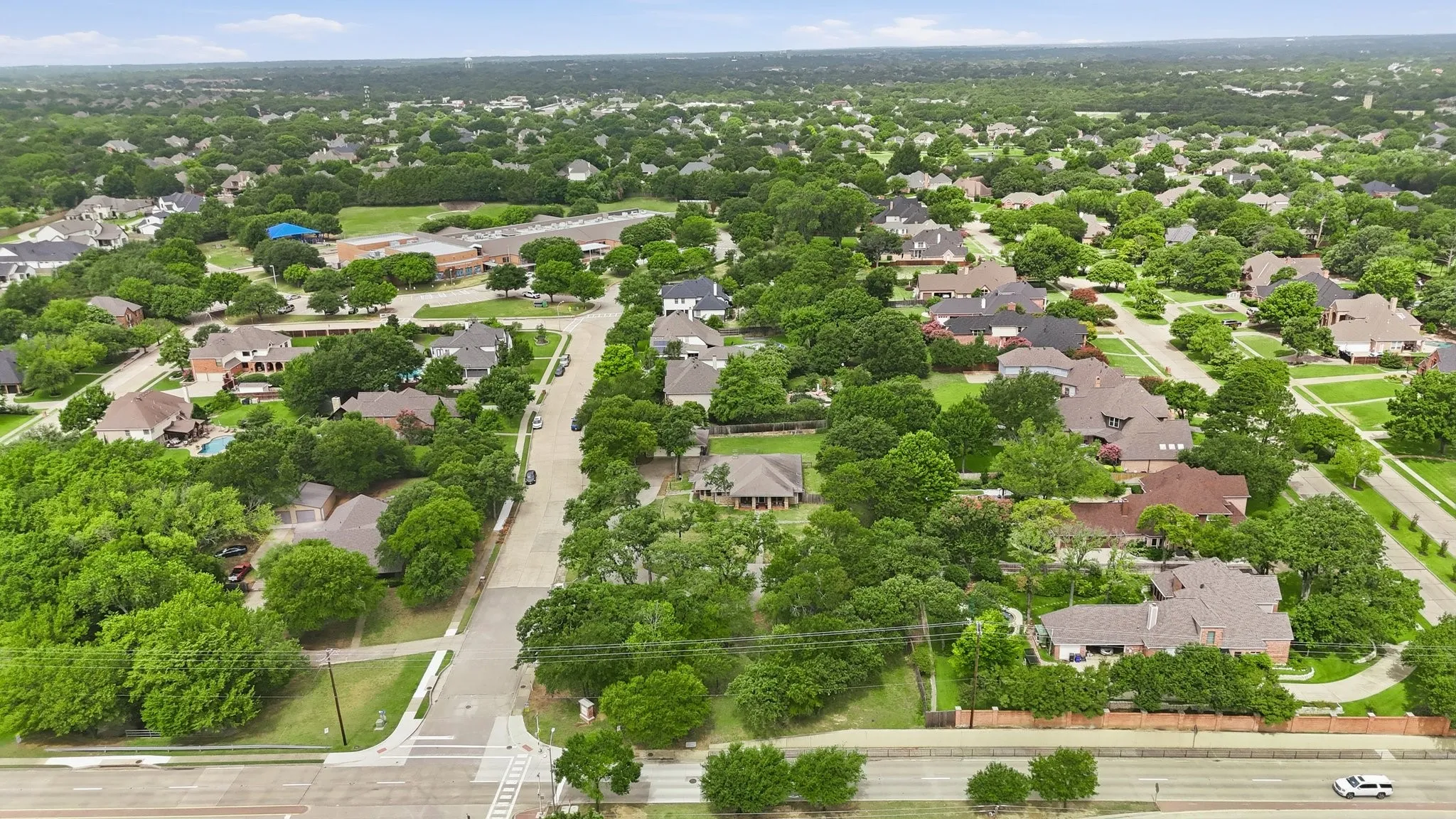 Tree-lined residential area featuring a mix of single-story and multi-story homes