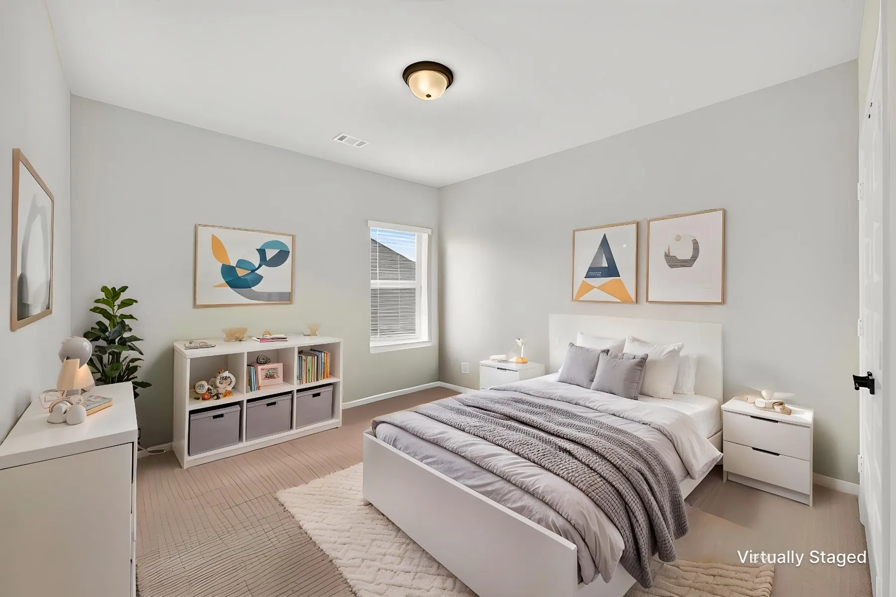 Light-filled bedroom featuring a vaulted ceiling and neutral wall tones