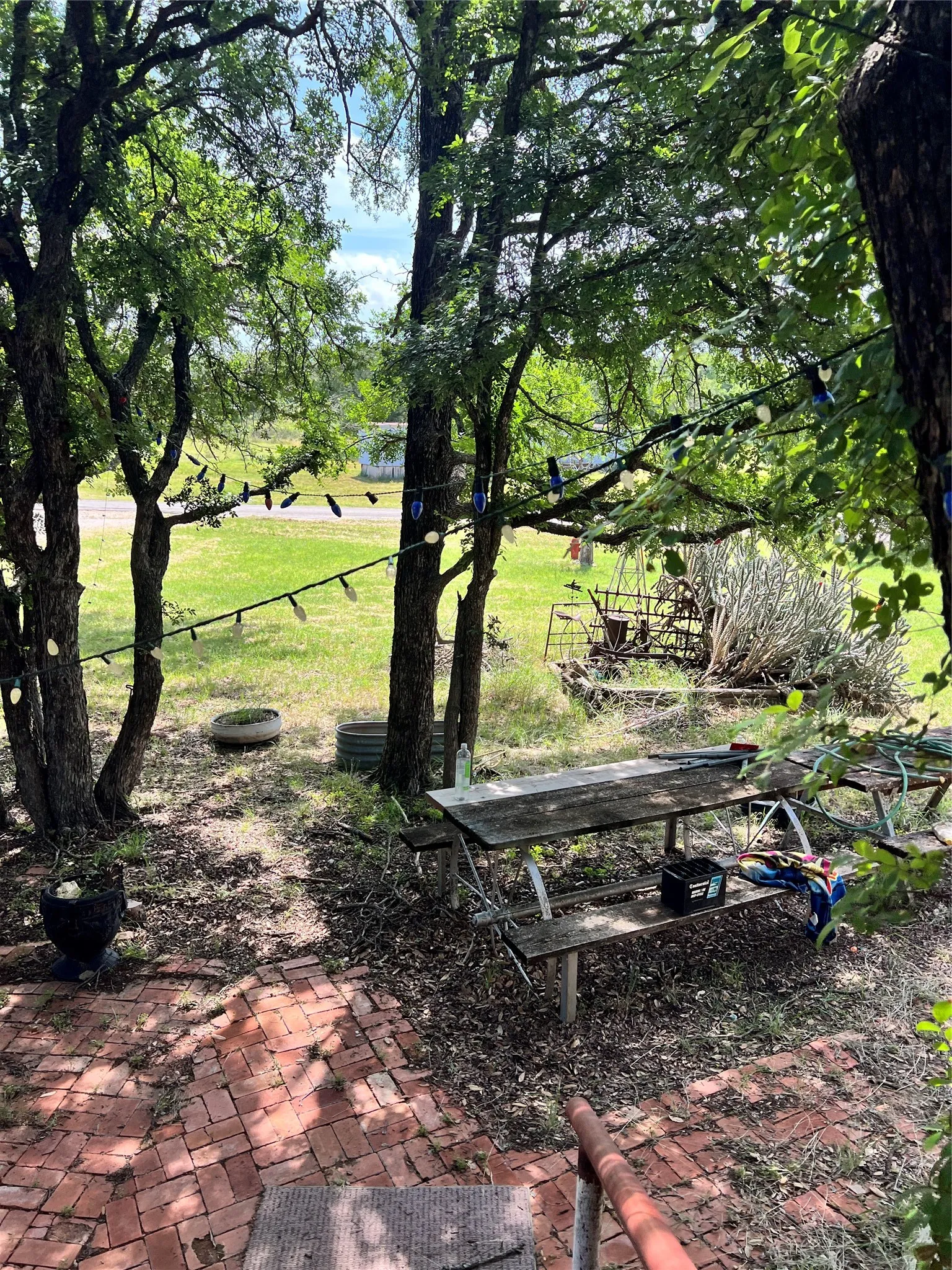 View of green lawn featuring an outbuilding