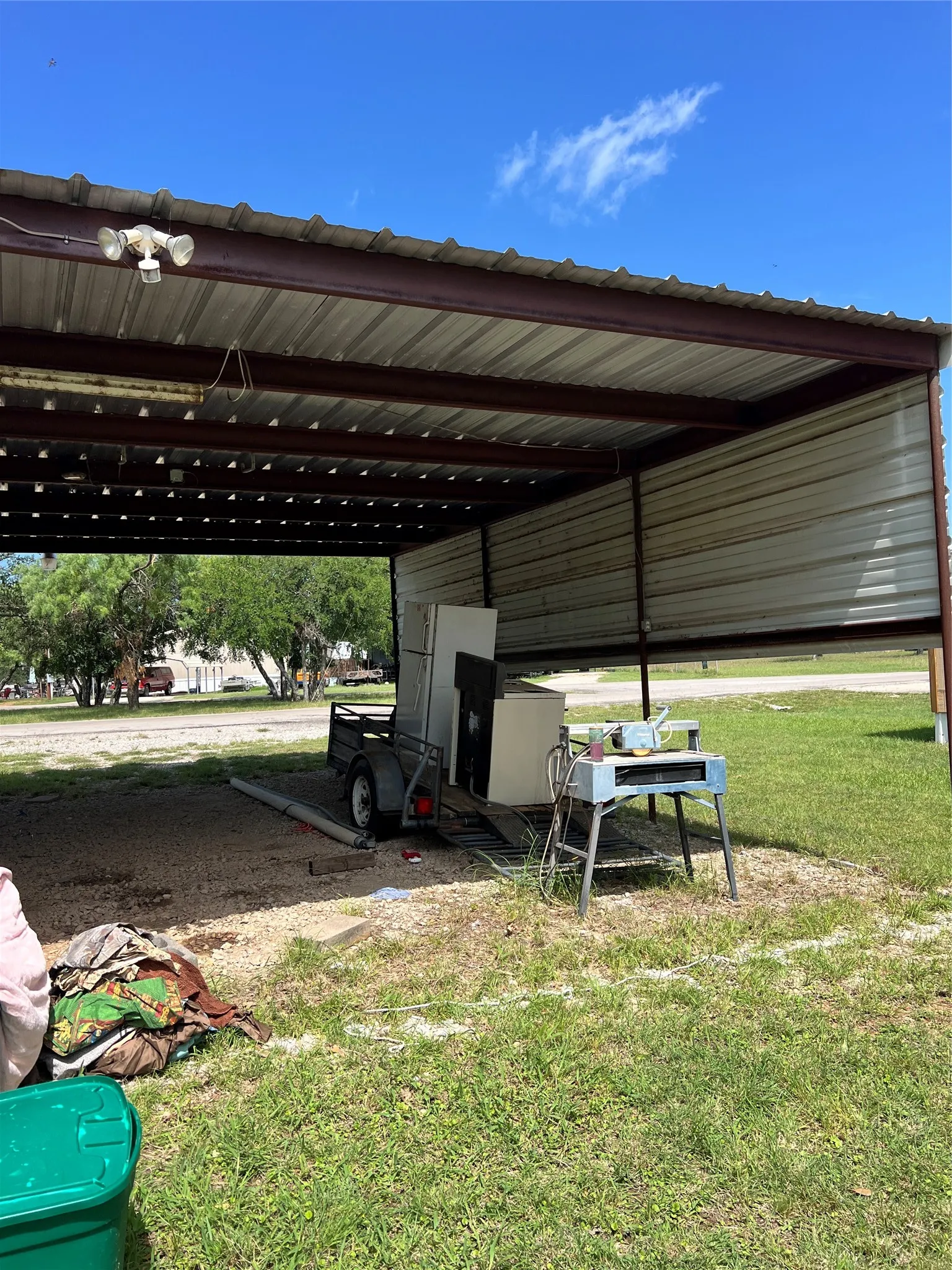 View of boat/truck parking featuring a carport and storage room
