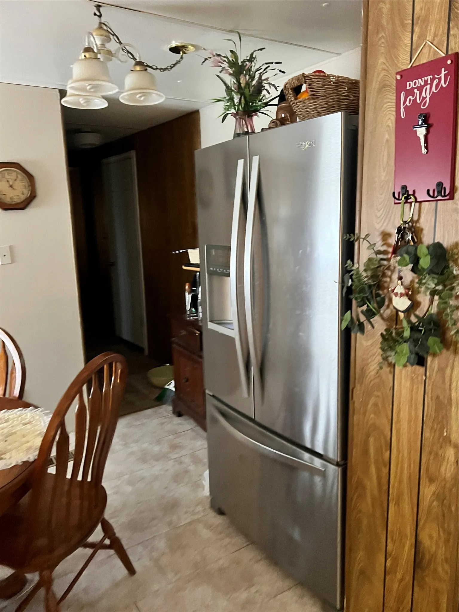 Kitchen with stove, dark brown cabinetry, and light countertops
