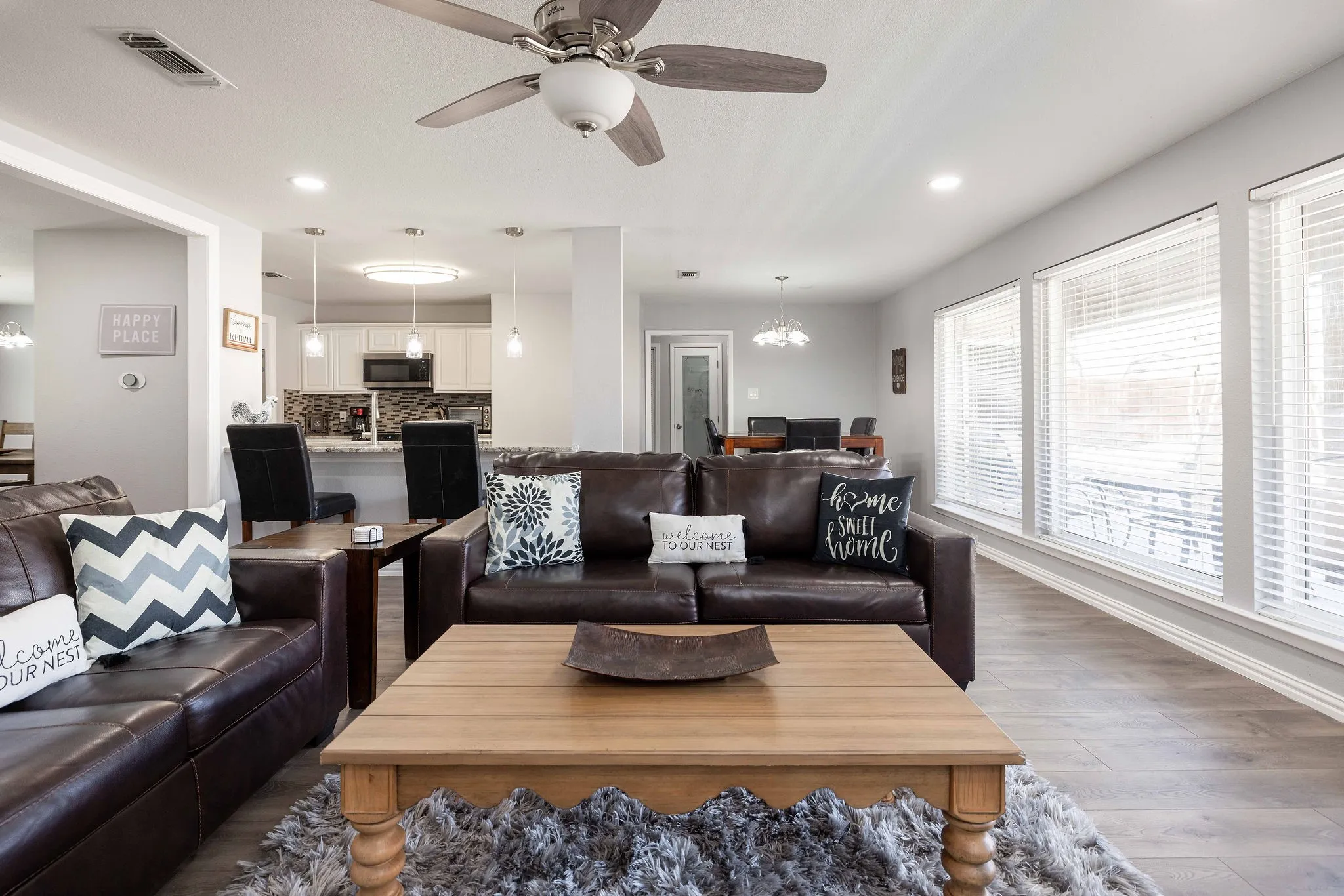 Living area featuring a chandelier, dark wood-style floors, ceiling fan, recessed lighting, and baseboards