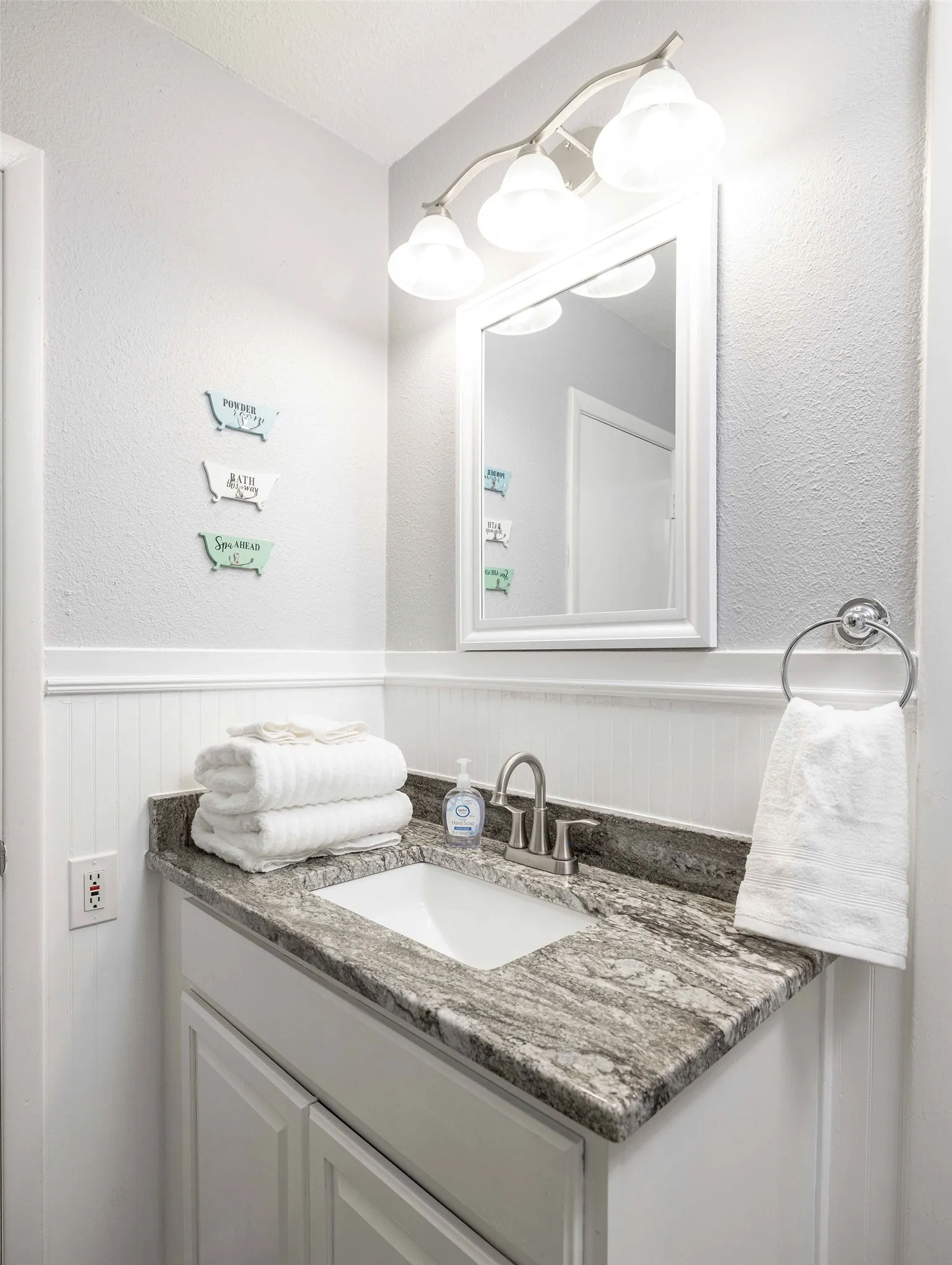 Bathroom featuring vanity and a wainscoted wall