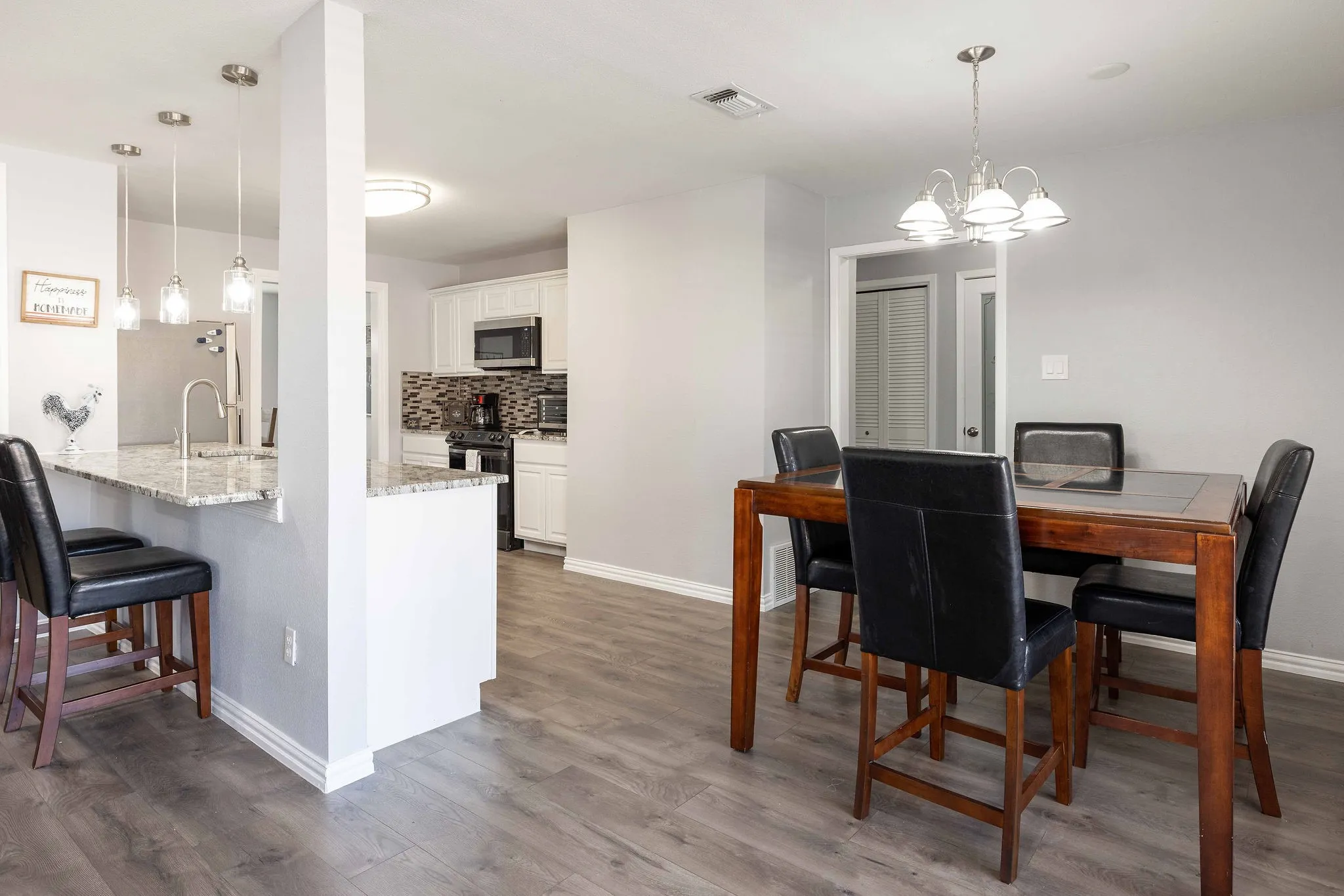 Dining space featuring dark wood finished floors, baseboards, and a chandelier