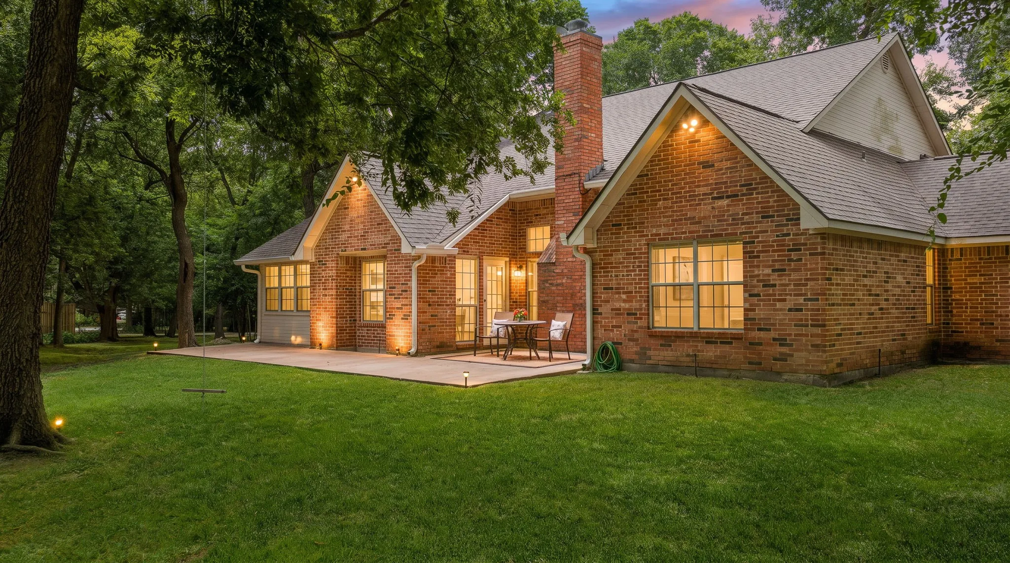 Extended back patio shaded by mature trees.