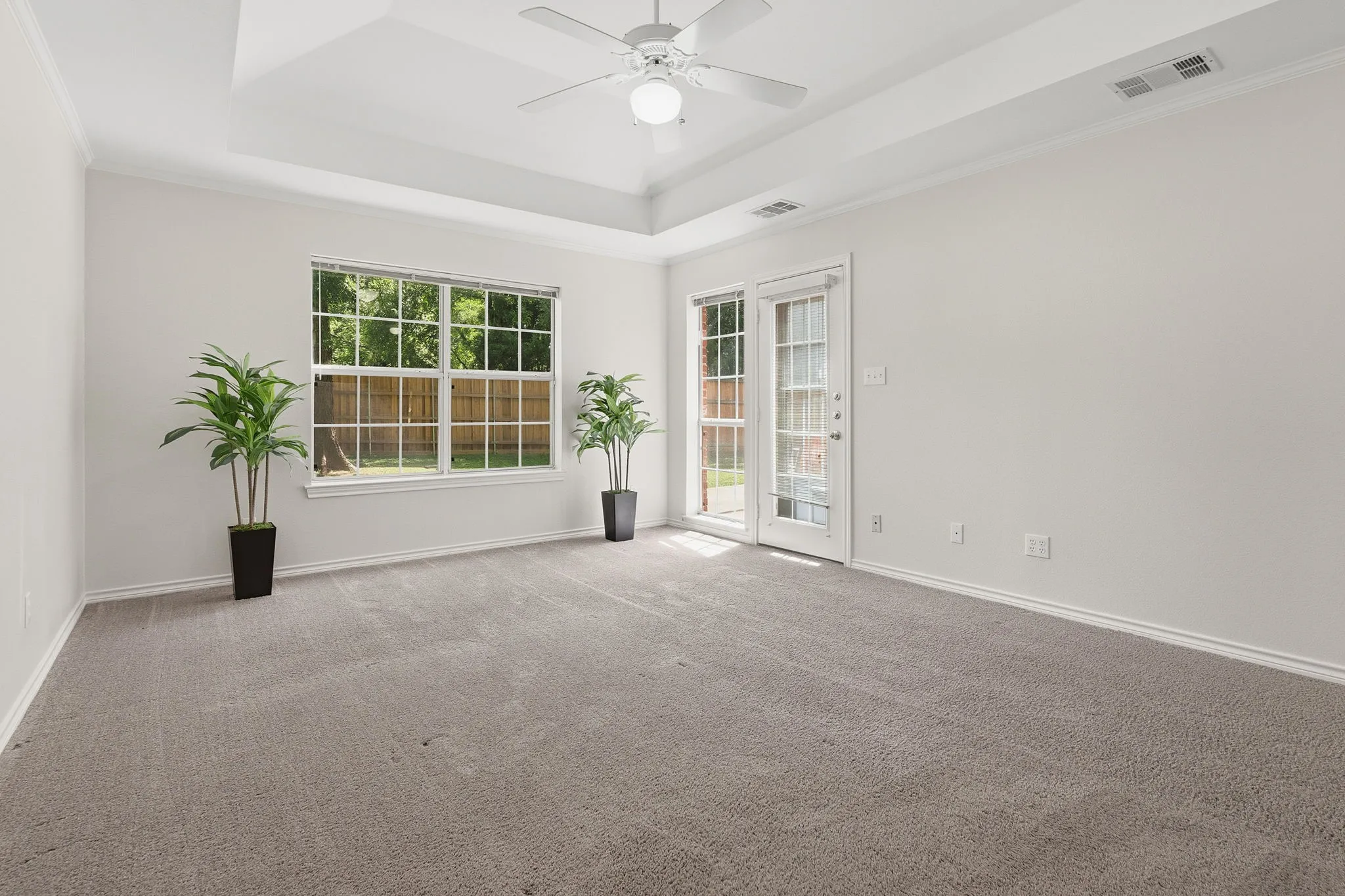 The primary suite features a door to pation and ensuite bath with oversized garden tub, walk-in shower, dual sinks, and a large walk-in closet.