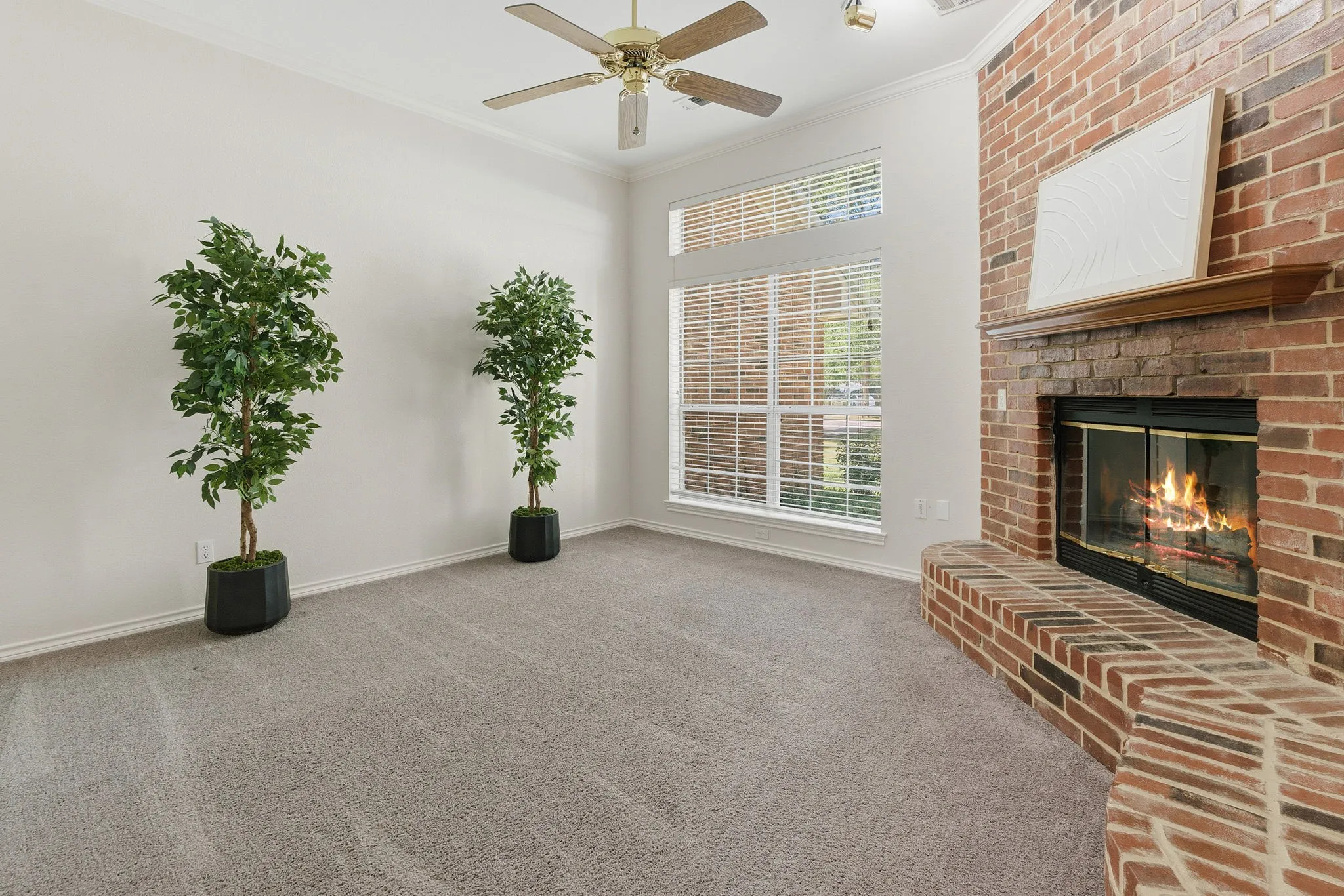 Bedroom offers French doors, a red brick wood-burning fireplace with blower, and wonderful flexibility as a bedroom, office, den, library, or additional living area.