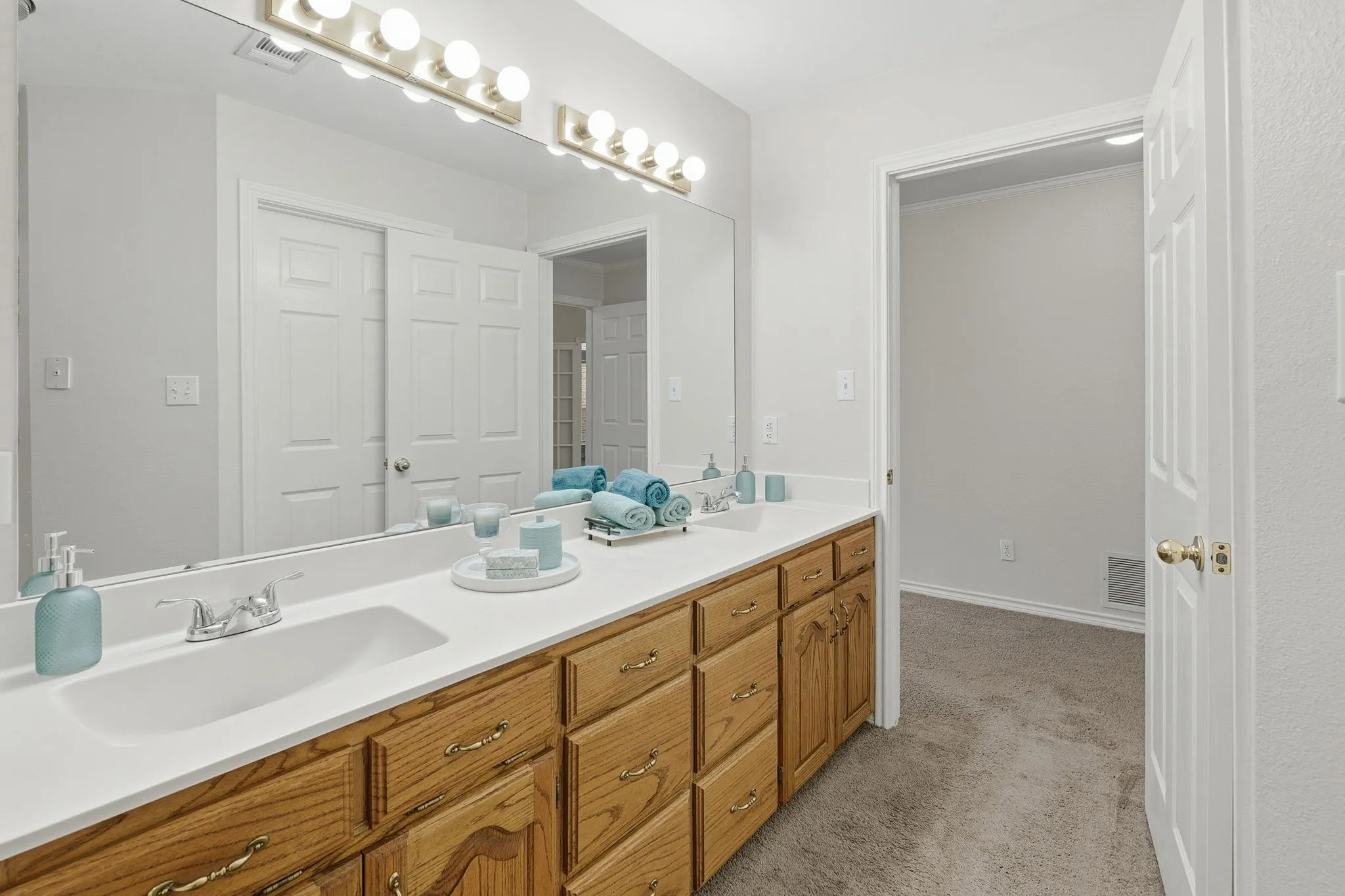 The primary suite features a door to pation and ensuite bath with oversized garden tub, walk-in shower, dual sinks, and a large walk-in closet.