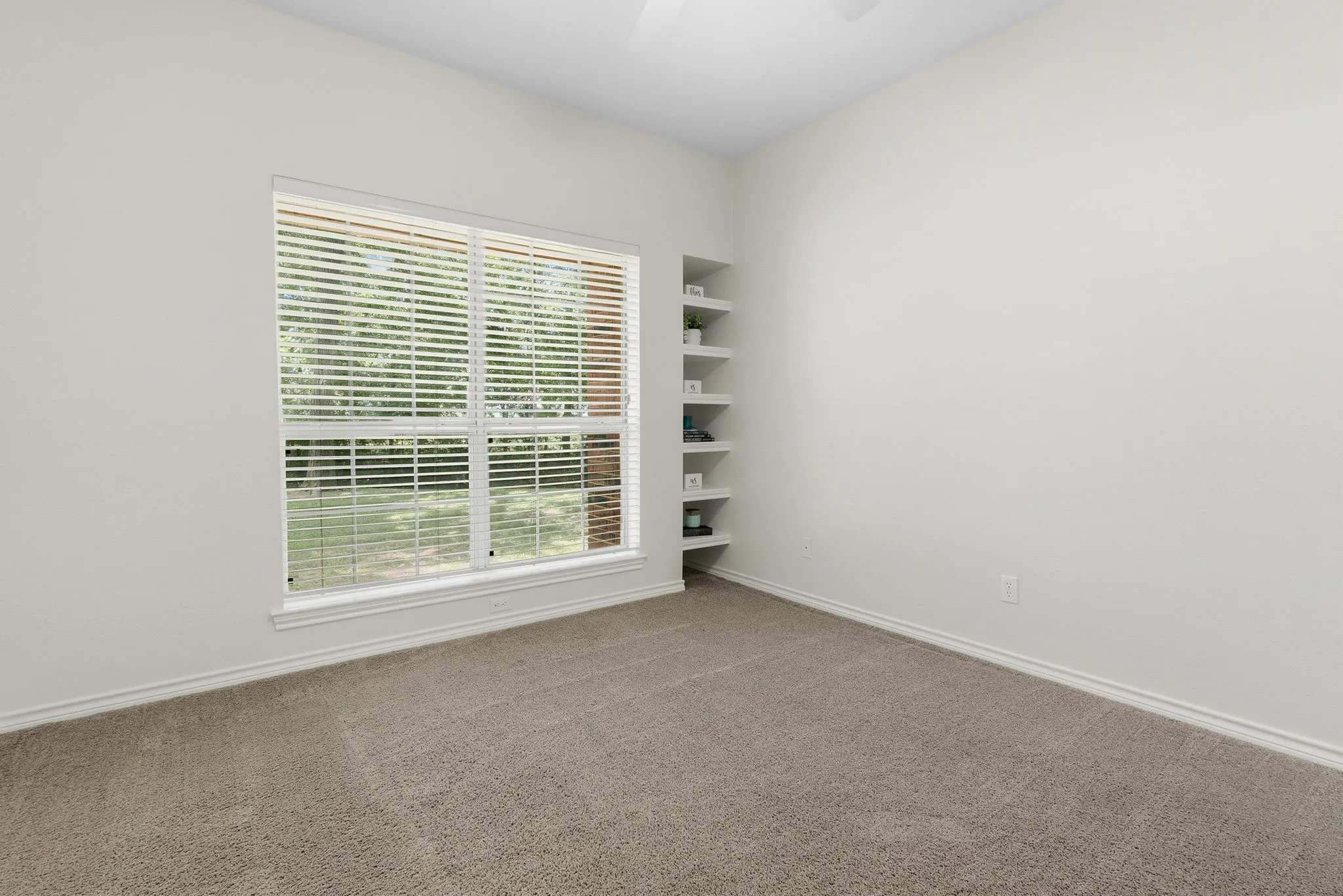 Secondary bedroom includes built-ins and a large closet with extra storage.